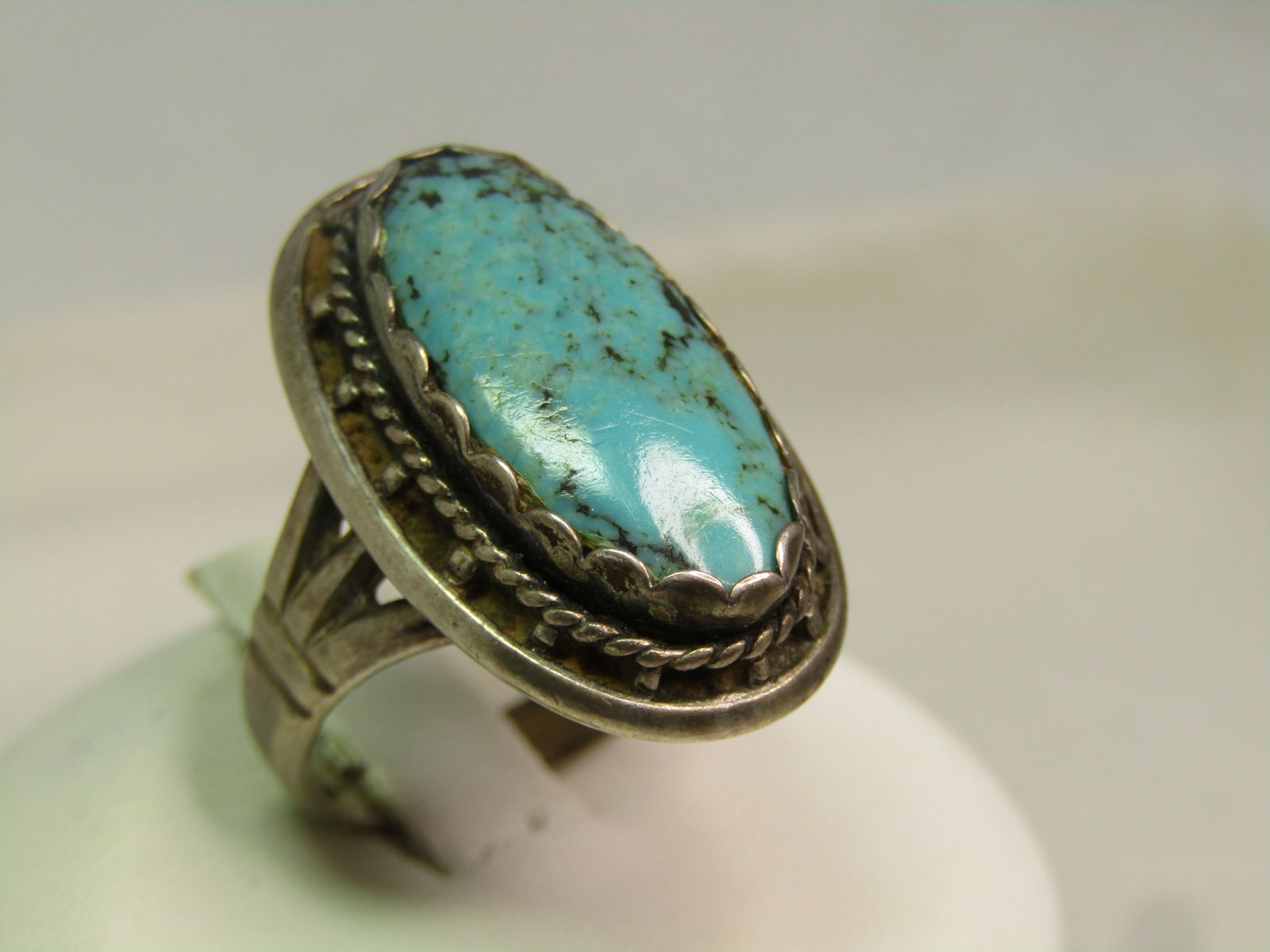 Vintage Sterling Southwestern Ring, Sz. 7, 1960's-1970's, Signed: Vintage Sterling Southwestern Ring, Sz. 7, 1960's-1970's, Signed with a kachina stamped hallmark. The turquoise stone is oval and set in a scalloped bezel - the stone is appx. 20mm by 9mm it has a fla