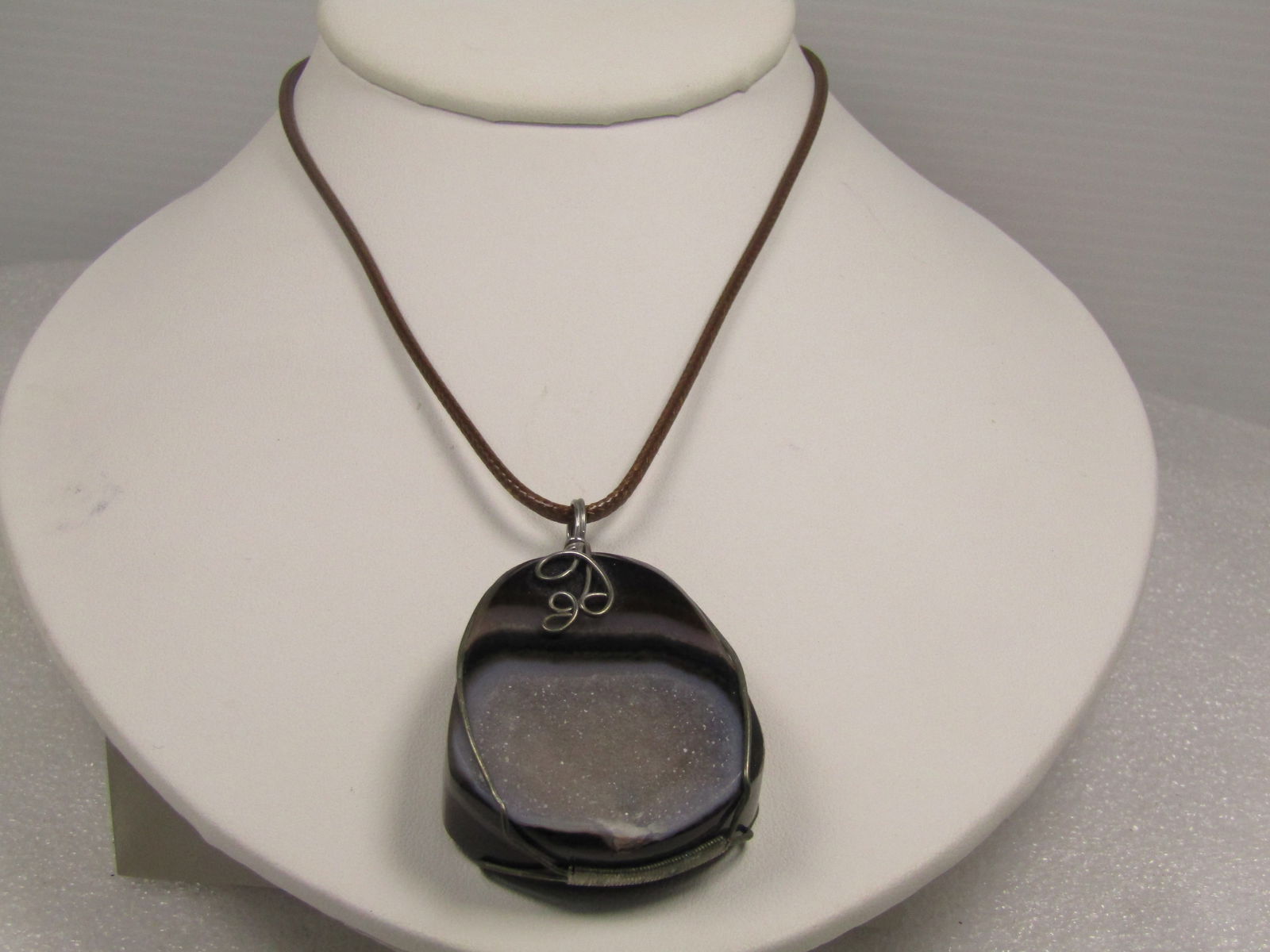 Brown Montana Druzy Agate Pendant on Brown Cord Necklace, 18"-20", 1980's-1990's: Brown Montana Druzy Agate Pendant on Brown Cord Necklace, 18"-20", 1980's-1990's. This is a thick and chunky agate with dark brown, chestnut brown and white bands and flat on the back with a depressed