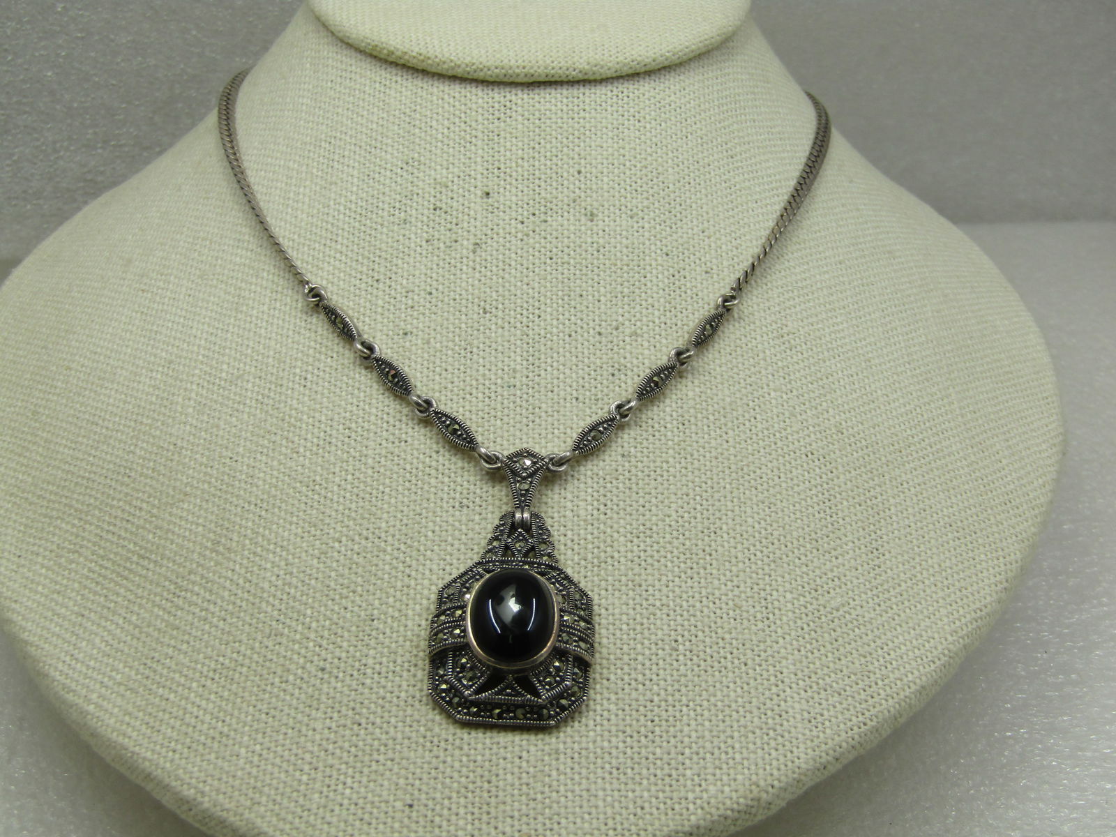 Vintage Sterling Onyx Lavalier Marcasite Lavalier Necklace, 16": Vintage Sterling Onyx Lavalier Marcasite Lavalier Necklace, 16" Herringbone. It is marked .925 on the spring clasp and the chain and pendant have been tested and both test as .925. Weight of the