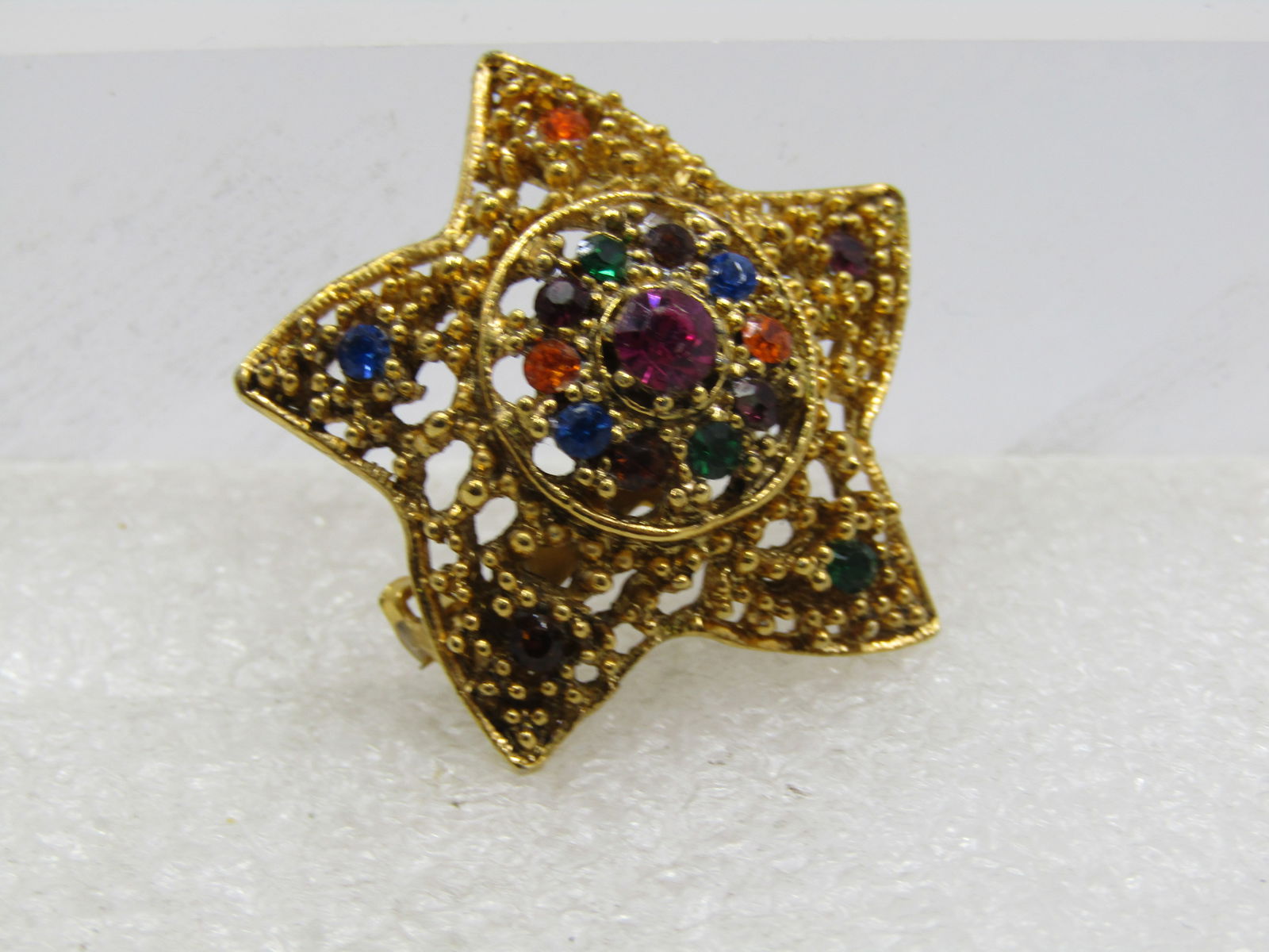 Vintage Rhinestone Domed Star Brooch, 1960's-1970's: Vintage Rhinestone Domed Star Brooch, 1960's-1970's, Gold Tone in red, green, orange, blue, gold, and brown. It is appx. 1.25" across. Not signed or marked Very good condition. (W52122.5 SS7713 AZ LEB