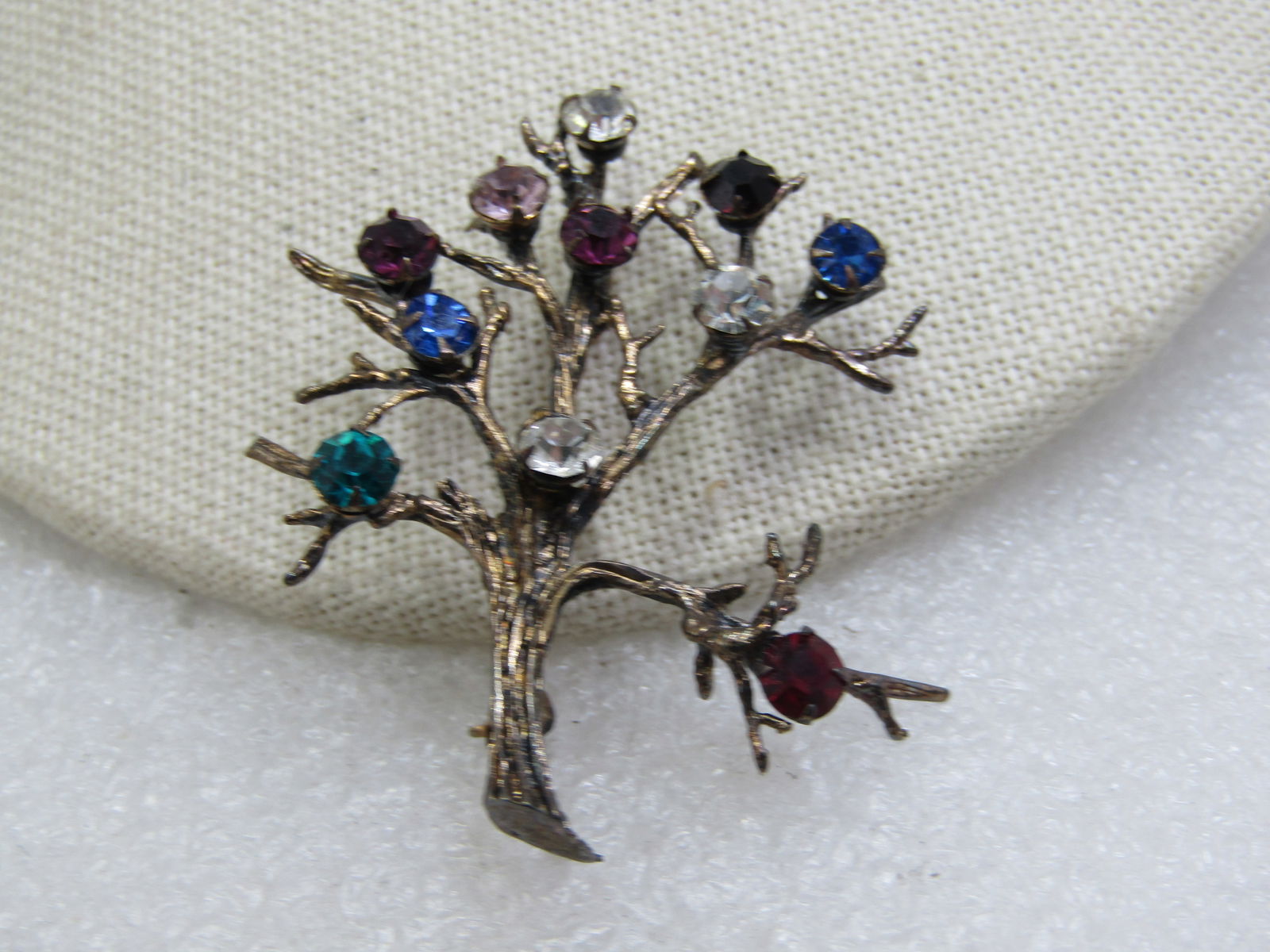 Vintage Sterling Tree/Branch Brooch with Rhinestones, Signed H: Vintage Sterling Tree/Branch Brooch with Rhinestones, Signed H. Marked sterling and weight is appx. 8.16 gr. There are 11 glass faceted stones, appx. 4mm wide in clear, red, blue, aqua, and red. 