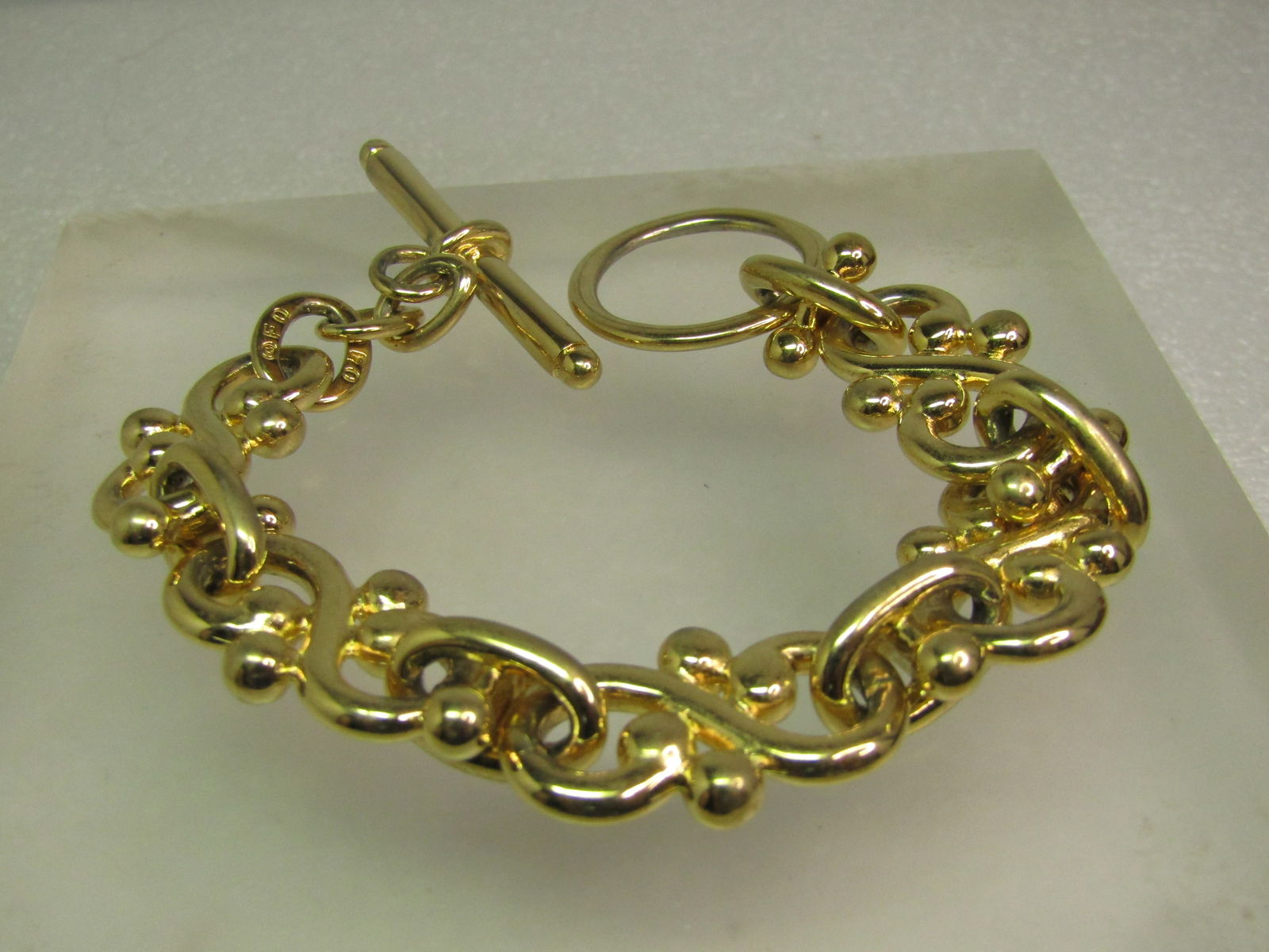 Vintage Wide S Fancy Link Bracelet, Togget Clasp, 8", Signed F.O., 1980's-1990's: Vintage Wide Infinity Fancy Link Bracelet, Togget Clasp, 8", Signed F.O., 1980's-1990's is the best estimate for this piece. The maker F.O. is unknown - there are a few companies that used this mark