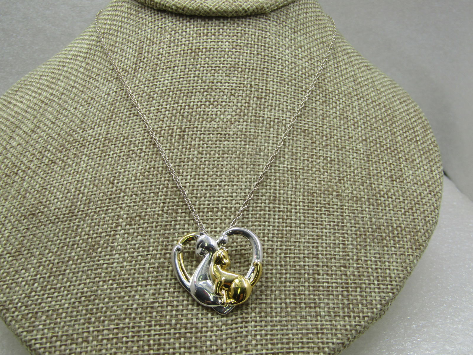 Vintage Four Leaf Clover Heart & Bow Brooch, 1940's: Vintage Four Leaf Clover Heart & Bow Brooch, 1940's. Gold tone double looped bow on top with a clear heart dangle with a real four-leaf clover preserved. It is 1.75" long and 1.25" wide at the bow. It