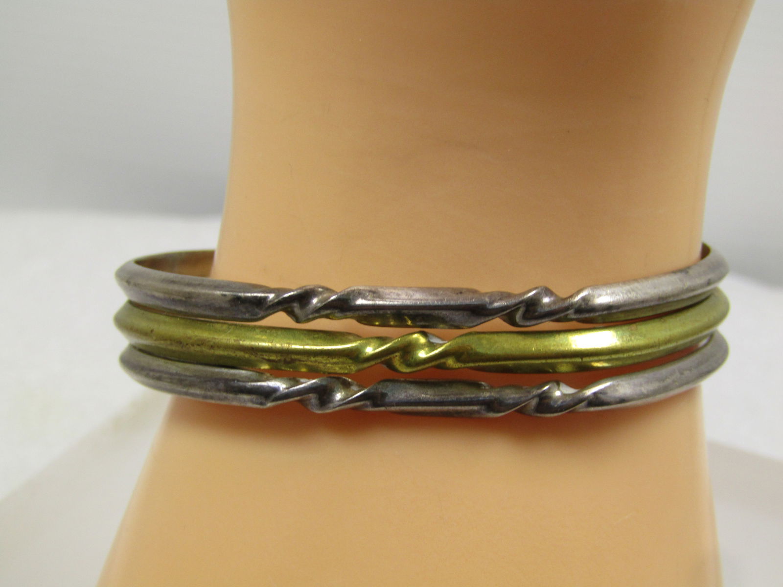 Vintage Sterling & Brass Cuff Bracelet , 7", Mexico 1980', Signed: Vintage Sterling & Brass Cuff Bracelet , 7", Unisex. Mexico 1980', Signed Laton. The opening is appx. 2.5" wide and1.75" front-to-back. The outer edge bands are sterling and the center is brass. The e