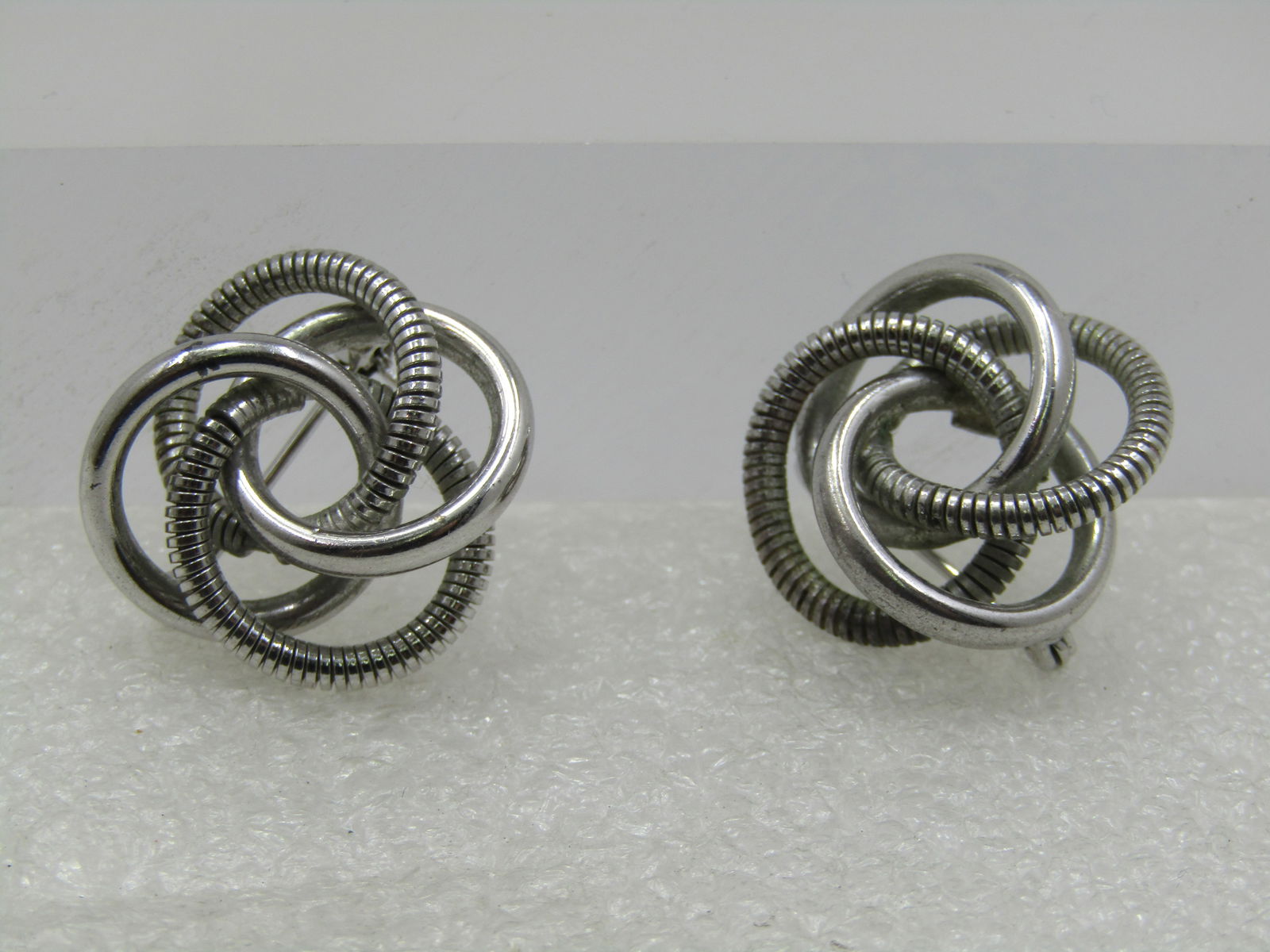 Vintage Sterling Pair Rhinestone Spiral Brooches, 7/8", 1960's: Vintage Sterling Pair Rhinestone Spiral Brooches, 7/8", 1960's. This has textured and smooth intertwined circles - four separate circles that are appx. 2.3mm wide that are intertwined to created the