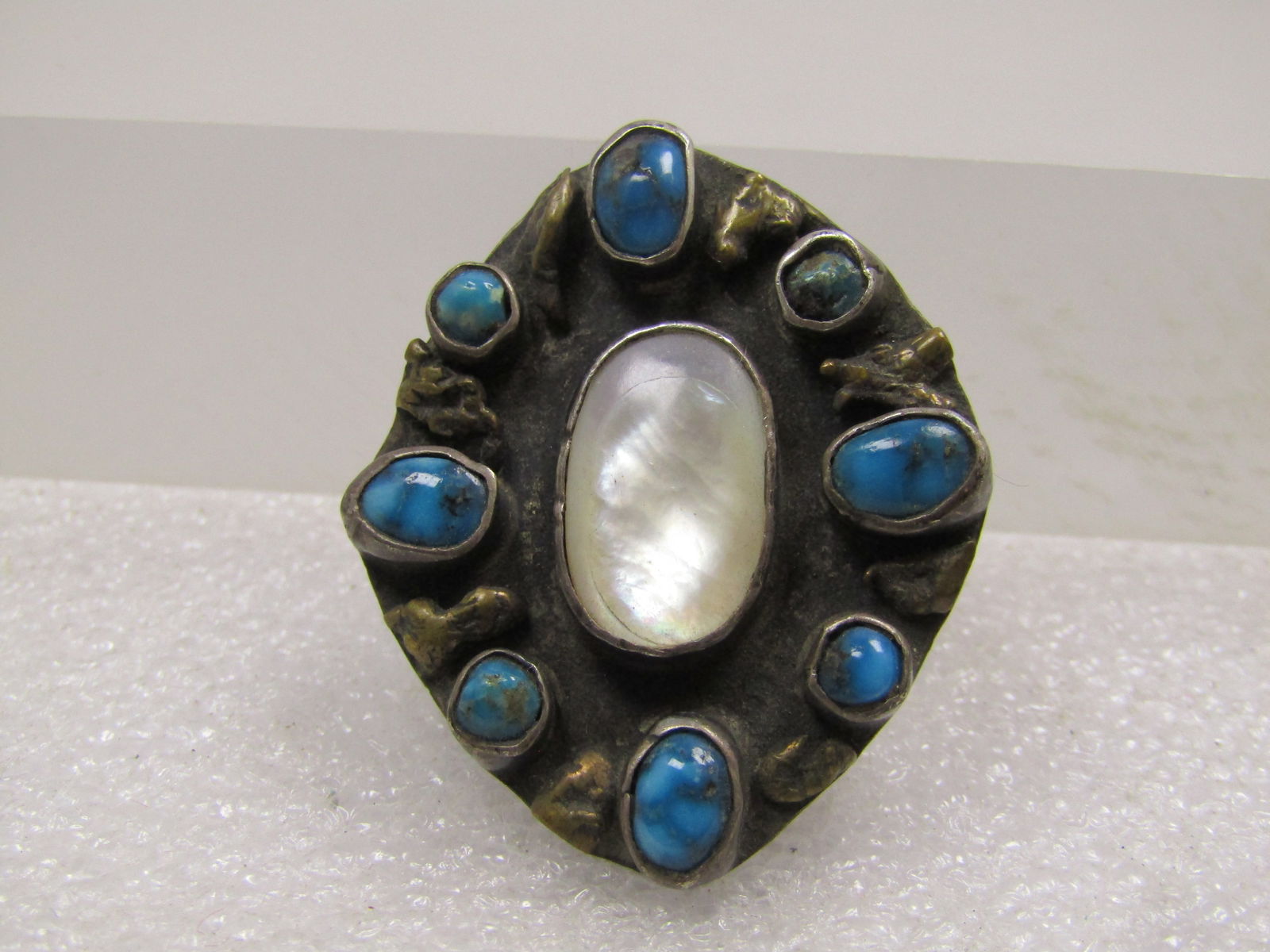 Vintage Sterling Southwestern MOP Turquoise Pendant, 1950's-1960's: Vintage Sterling Southwestern MOP Turquoise Pendant, 1950's-1960's. These stones are set raised on the sterling background with brass nugget accents between each of the turquoise stones which are oval