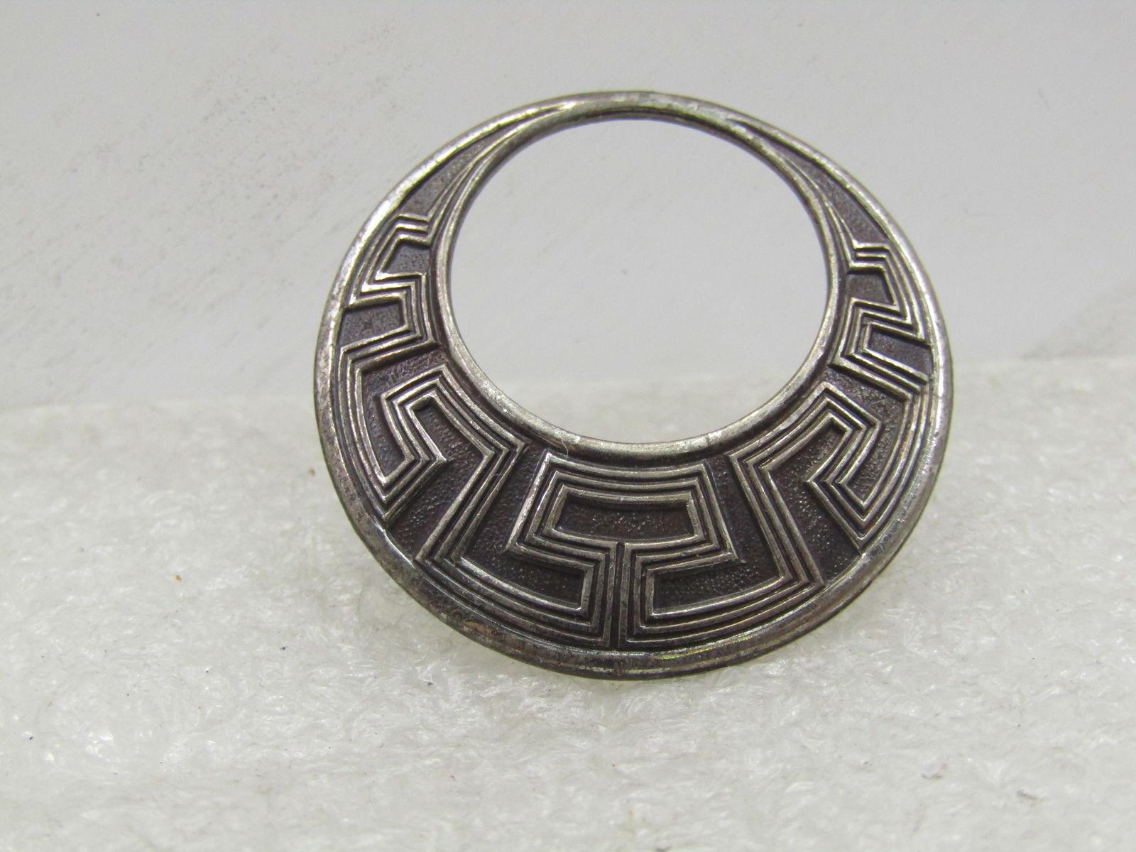 Vintage Sterling Ridged Circle Brooch, Offset, 1960's, 1-1/8": Vintage Sterling Ridged Circle Brooch, Offset, 1960's, 1-1/8". This almost looks like a collar necklace. It is marked sterling and tested. It has a raised ridged design that looks Southwestern but can