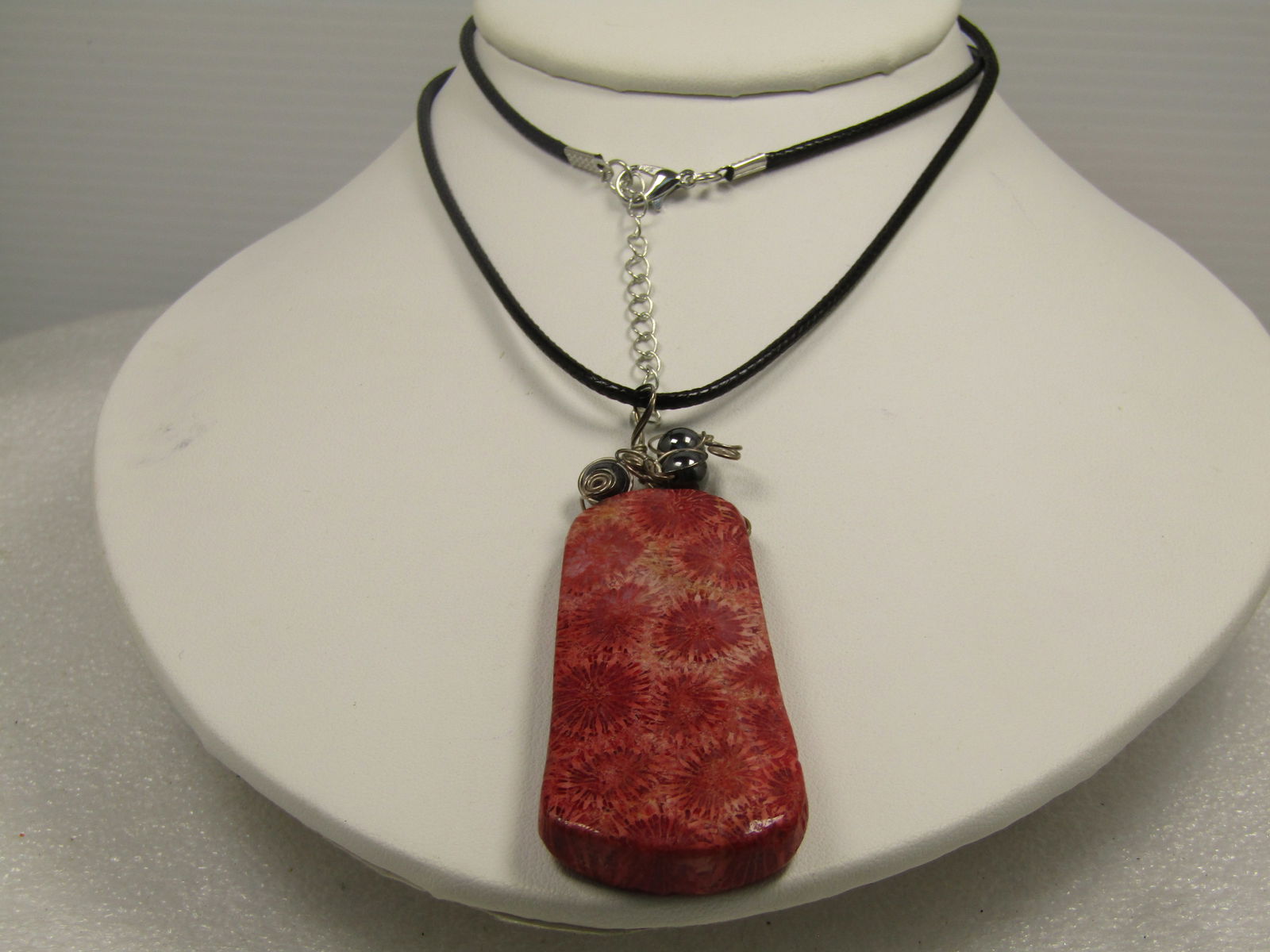 Sterling Fossil Agate & Hematite Pendant Necklace, 24"-26": Sterling Fossil Agate & Hematite Pendant Necklace, 24"-26". The pendant is a hand-wrapped.3-1/8" tall pendant that is appx. 1-1/8" wide and appx. 8mm thick. There are three hematite beads threaded in