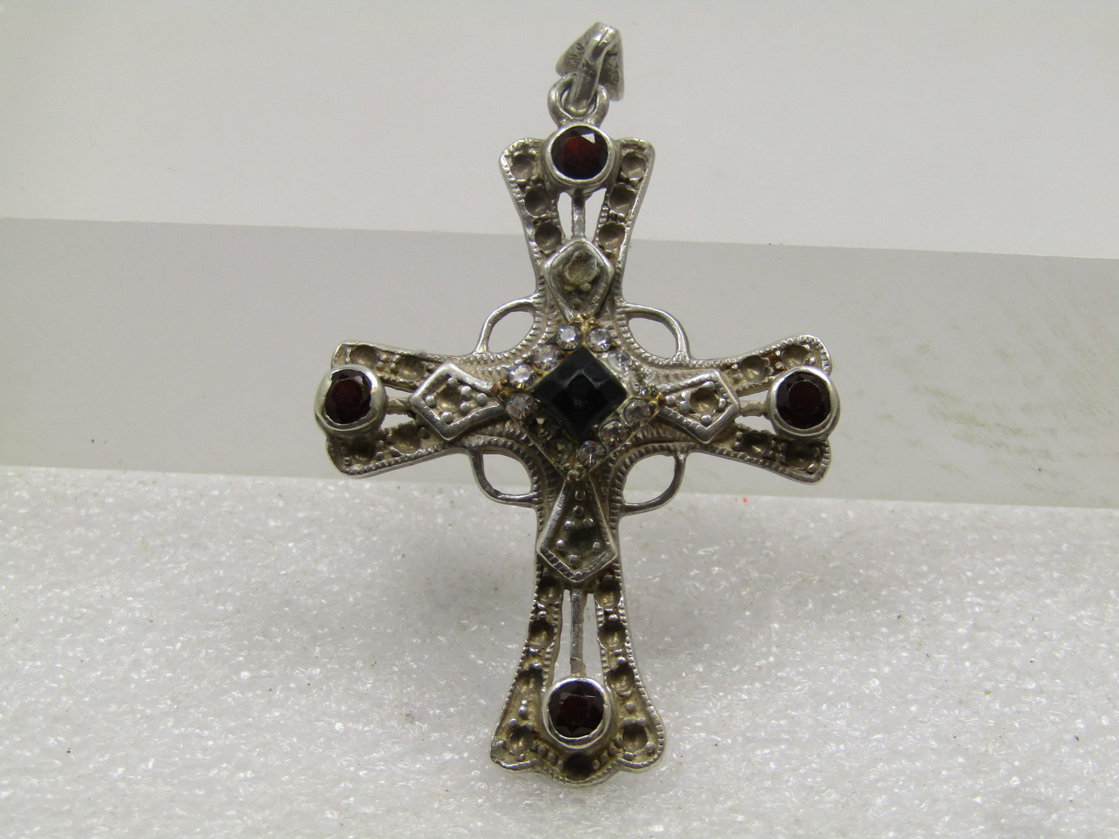 Vintage Sterling Cross Pendant, Black/Clear Glass Stones , 1980's-1990's: Vintage Sterling Cross Pendant, Red/Black/Clear Glass Stones , 1980's-1990's. This has red glass, bezel-set stones on the ends of the cross and in the center raised black square stone, set on it's poi