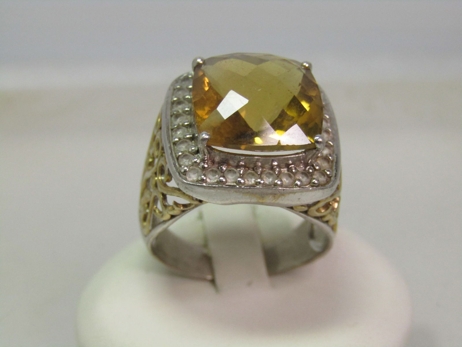 Sterling Citrine & Topaz Statement Ring, Sz. 10.5, CTW 8.92, 1990's: Sterling Citrine & Topaz Statement Ring, Sz. 10.5, CTW 8.5, 1990's. Mix of sterling with vermeil filigree scrolled details on each of the ring. The stone is a domed honeycomb cushion cut citrine that