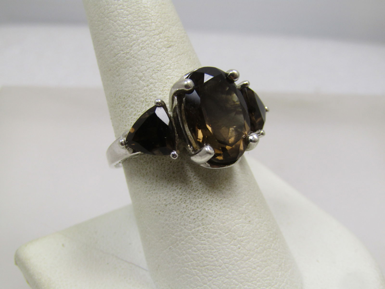 Sterling Triple Smoky Topaz Ring, Sz. 8.5, Signed JRT, Thailand, 1990's: Sterling Triple Smoky Topaz Ring, Sz. 8.5, Signed JRT, Thailand, 1990's or after. It has a center smoky topaz that is appx. 13.5mm by 9.5mm oval. It is an appx. 5 ctw stone . The side stones are appx.