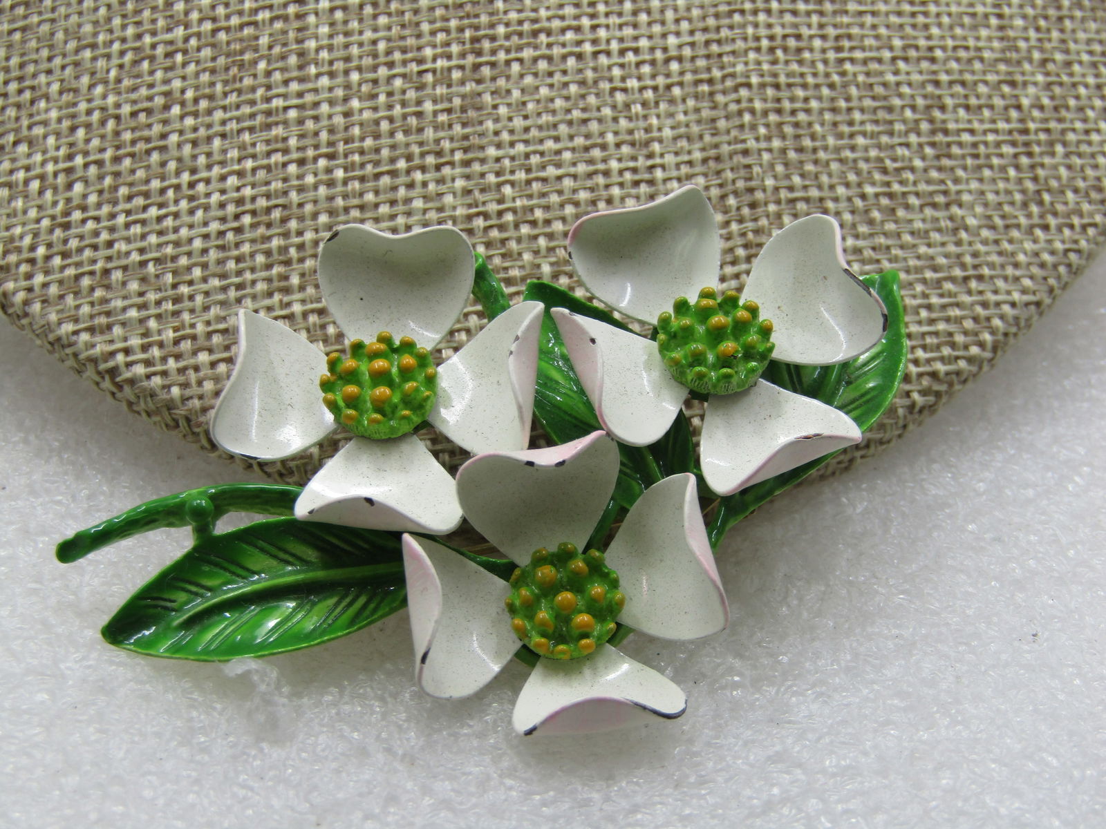 Vintage Enameled Dogwood Brooch, White/Green Mid-Century: Vintage Enameled Dogwood Brooch, White/Green Mid-Century. Three white dogwood blossoms sitting on a base of bright green enameled leaves and stems. It is appx. 3" long and 2" wide and is in very