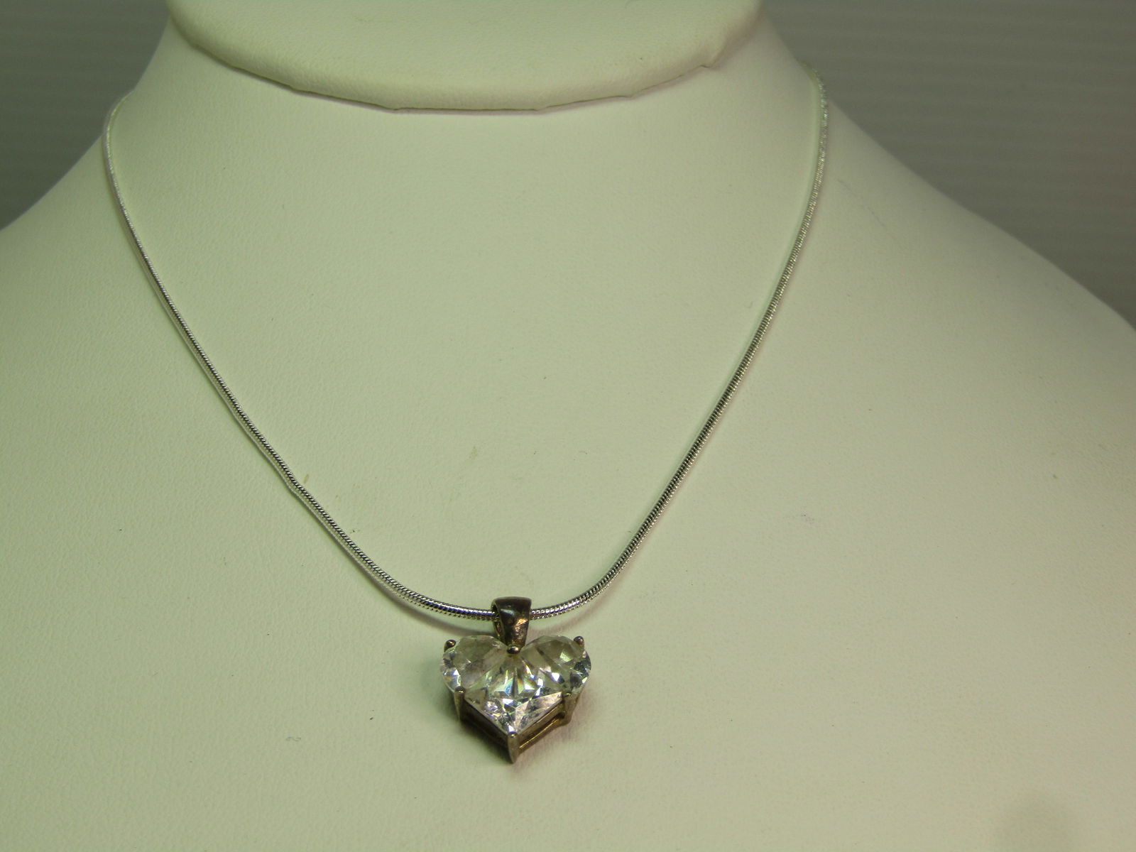 Vintage Sterlnig Heart CZ Necklace on 18" Serpentine Chain, 1980's-1990's: Vintage Sterlnig Heart CZ Necklace on 18" Serpentine Chain, 1980's-1990's. The chain is appx. 1mm round with lobster clasp. The chain has a rhodium plate anti-tarnish finish. It is marked .925 but I d