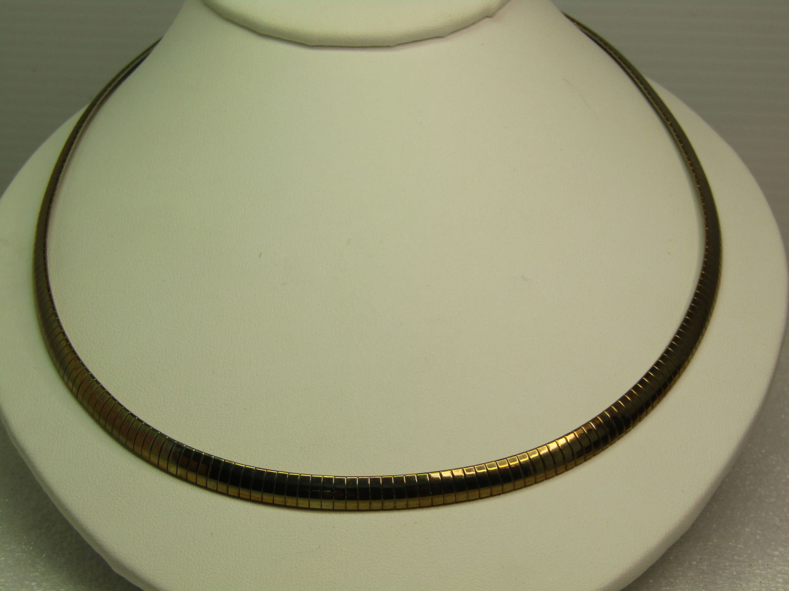 Vintage Gold Tone Omega Necklace, 20", 1980's-1990's: Vintage Gold Tone Omega Necklace, 20", 1980's-1990's. Very clean and bright 5.5mm wide omega link necklace with flip clasp. It is not marked or signed. Excellent condition - great to wear as is or wit