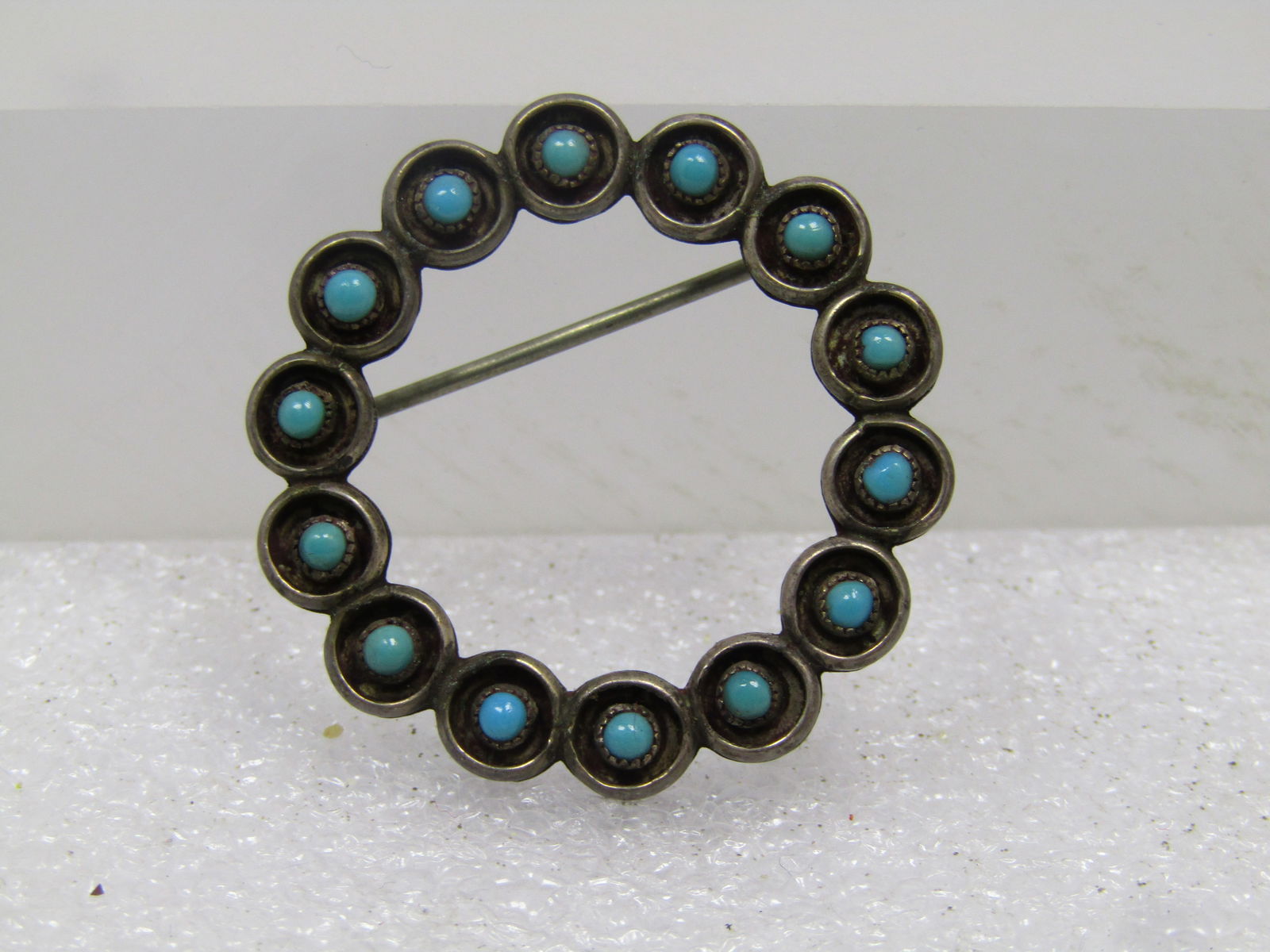 Vintage Sterling Southwestern/Zuni Turquoise Brooch, Circle, 1960's-1970's. Snake Eye Cabochons.: Vintage Sterling Southwestern Turquoise Brooch, Circle, 1960's-1970's. This style is believed to be a Zuni style and others like it were listed that way. It cannot be concretely stated as it is not si