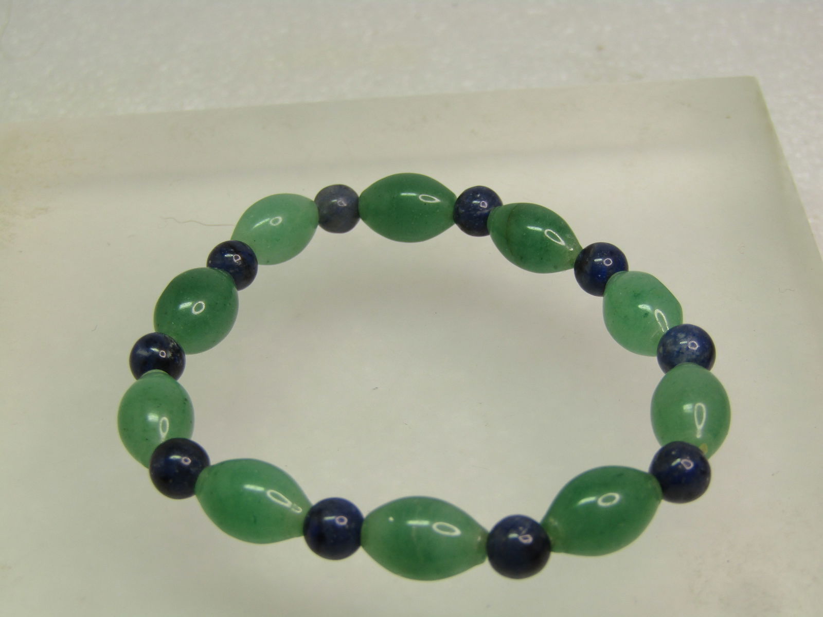 Beaded Jade/Nephrite and Sodalite Beaded Bracelet, Stretch, 1990's-2000's.: Beaded Jade/Nephrite and Sodalite Beaded Bracelet, Stretch, 1990's-2000's. The nephrite beads are oblong and wider in the center and are appx. 11.5mm long and 7.5mm at the center and the sodalite bead