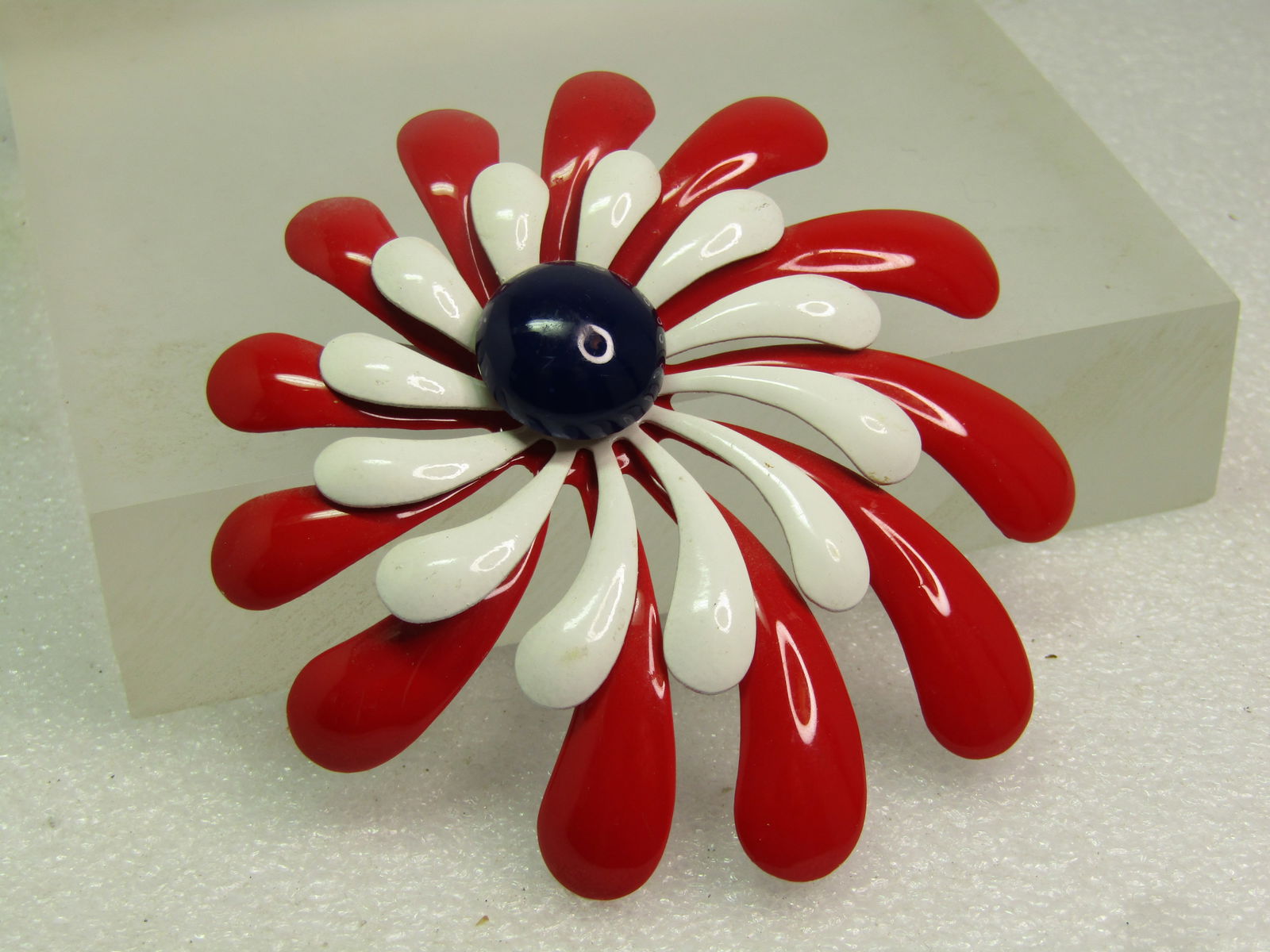 Vintage Enameled Red/White/Blue Blossom Brooch, 1960's-1970's: Vintage Enameled Red/White/Blue Blossom Brooch, 1960's-1970's. This has the look of a blossom or a splash. It is three tiers with red being the lowest tier and wider at the edge and thinner in the mid