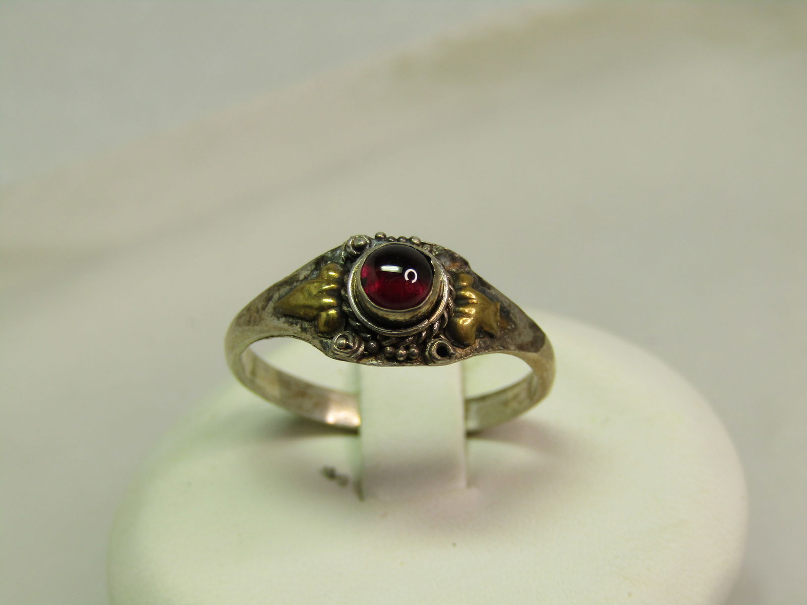 Vintage Sterling Garnet Ring, Sz. 8, Gold Tone Accents, Bali Themed, 1970's-1980's: Vintage Sterling Garnet Ring, Sz. 8, Gold Tone Accents, Bali Themed, 1970's-1980's This is marked .925 and tests as sterling with a weight of appx,. 1.53 grams. The garnet is appx. 3.5mm round and set