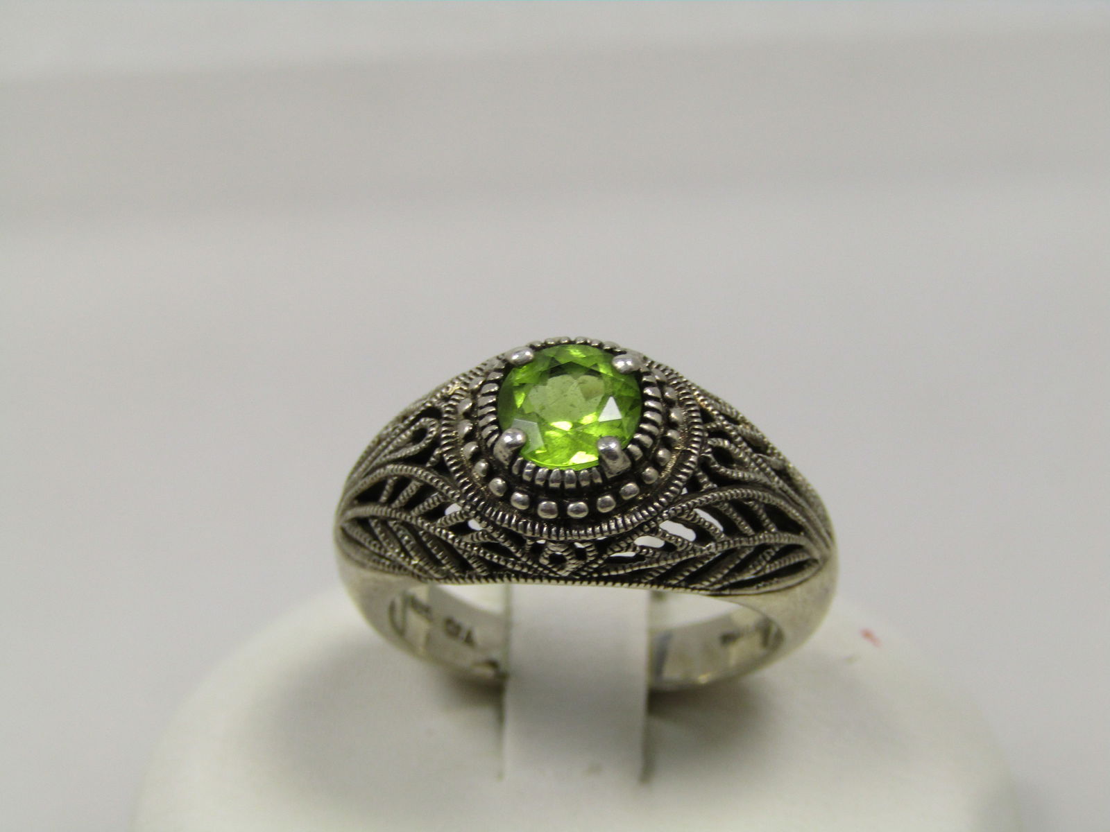 Vintage Sterling Peridot Ring, Sz. 6m Open Filigree, 1980's-1990's: Vintage Sterling Peridot Ring, Sz. 6m Open Filigree, 1980's-1990's. This is marked Thailand and signed CNA which is Chrystalline Northamerica part of Pranda Northamerica. Pranda, according to the inte
