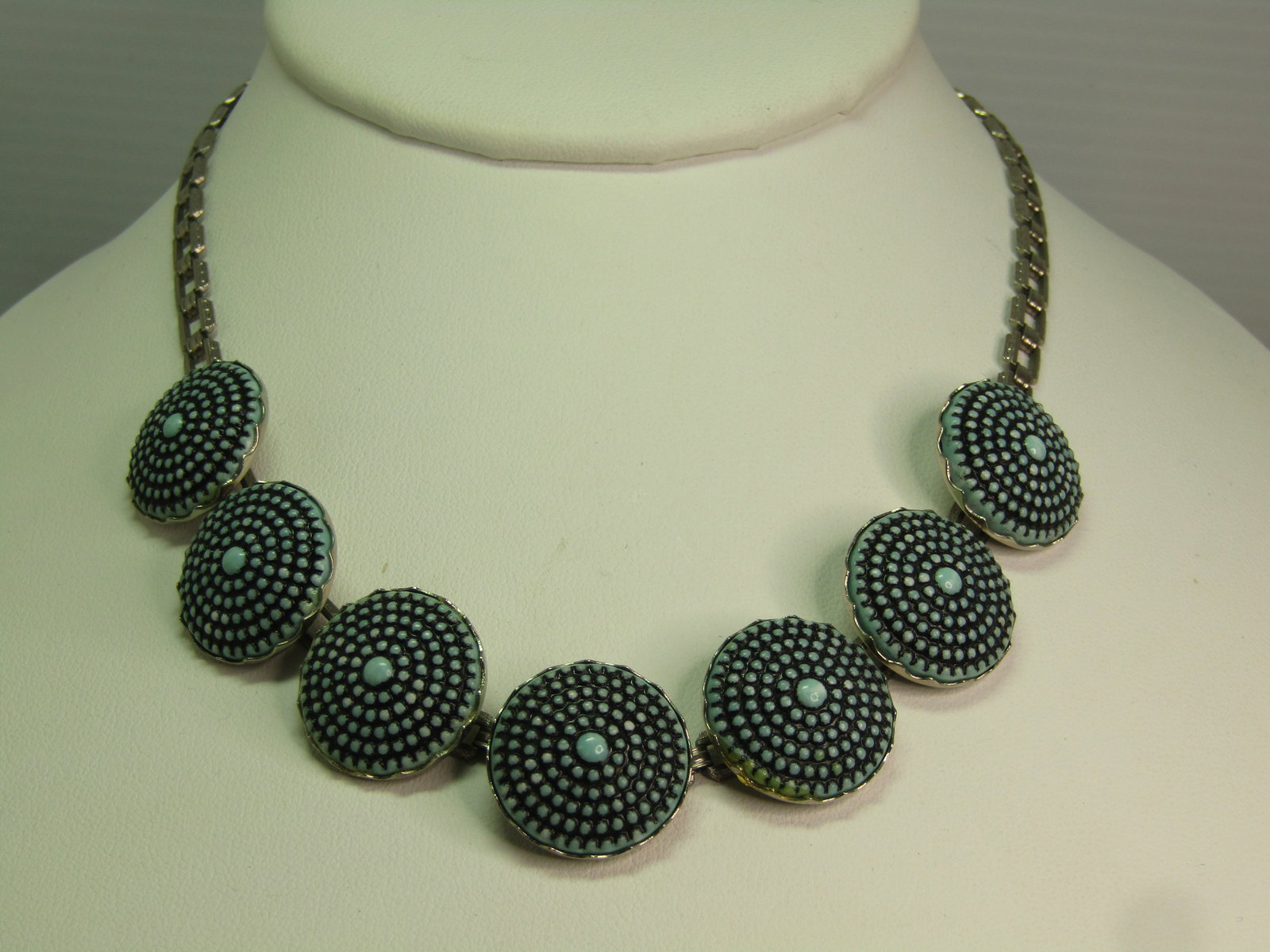 Vintage Pressed Turquoise Glass Tiered Necklace, 15", 1940's: Vintage Pressed Turquoise Glass Tiered Necklace, 15", 1940's. This has seven links with a domed pressed turquoie glass with black wash creating the look - in a way of a turquoise concho or something s