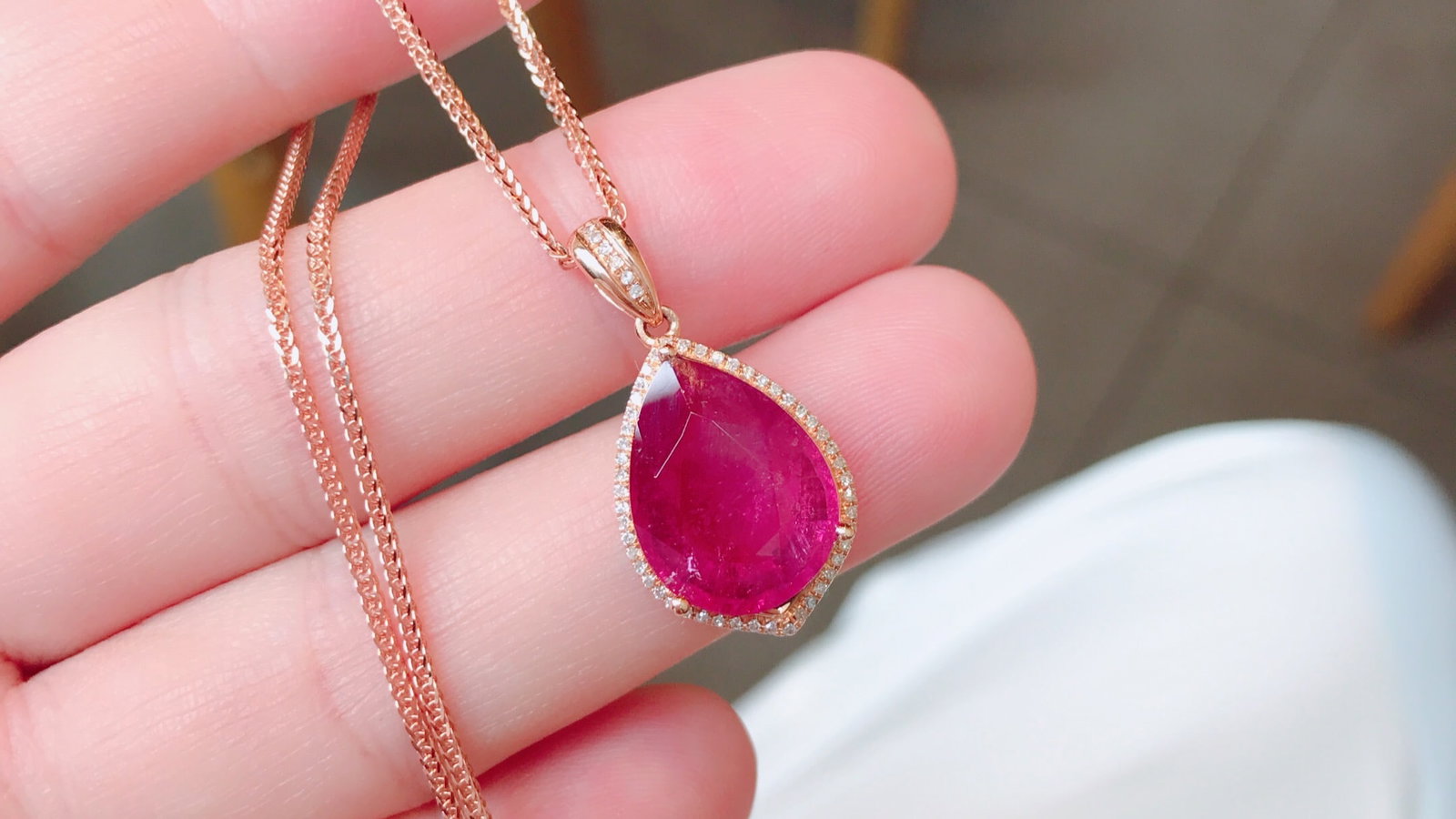 18K Gold Rubellite Tourmaline Pendant with 55 Diamonds, 6.4 ct Gemstone: Title: 18K Gold Rubellite Tourmaline Pendant with 55 Diamonds, 6.4 ct Gemstone Description: This exquisite pendant showcases a richly colored, round and full rubellite tourmaline weighing 6.4 ct, set
