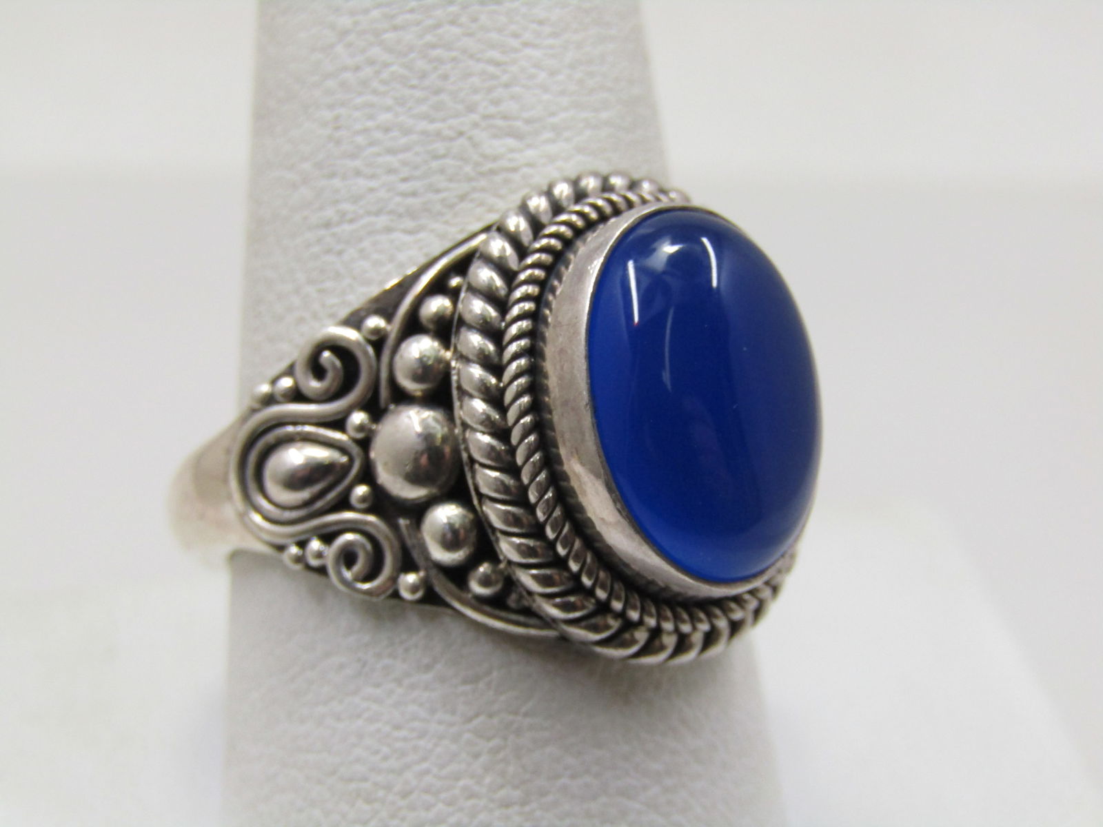 Sterling Blue Chalcedony Bali Ring, Sz. 10.5, Suarti: Sterling Blue Chalcedony Bali Ring, Sz. 10.5, Suarti. (Signed BA). This has an oval blue chalcedony cabochon that is bezel-set and appx. 14mm by 10mm in the setting. It has a double rope accent - wide