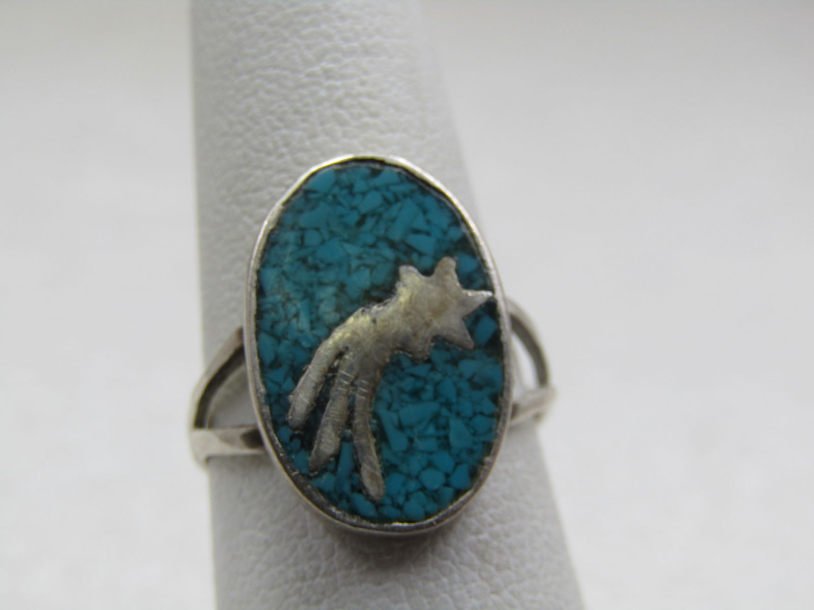 Vintage Sterling Southwestern Shooting Star Turquoise Ring, Sz. 6: Vintage Sterling Southwestern Shooting Star Turquoise Ring, Sz. 6. Inlaid silver shooting star set in a bed of turquoise chips with a bezel set oval frame. Split V band on top at 7mm wide and forming