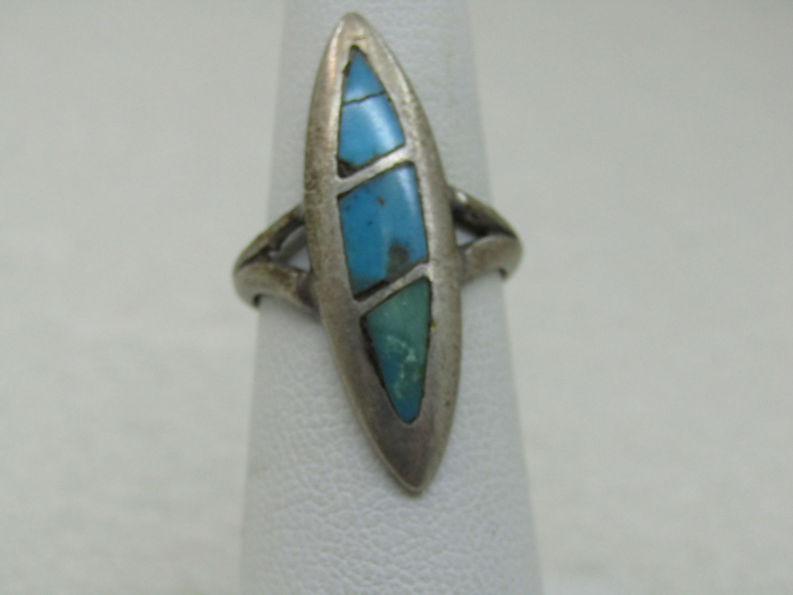 Vintage Stering Inlaid Turquoise Southwestern Ring, Sz. 5, 1.25" Long,: Vintage Stering Southwestern Inlaid Turquoise Ring, Sz. 5, Appx. 4.13 gr., 1.25" Long, 1/3" wide and pointed at the ends. It has a split V band at top where it attaches to the ring and is appx. 5.8mm