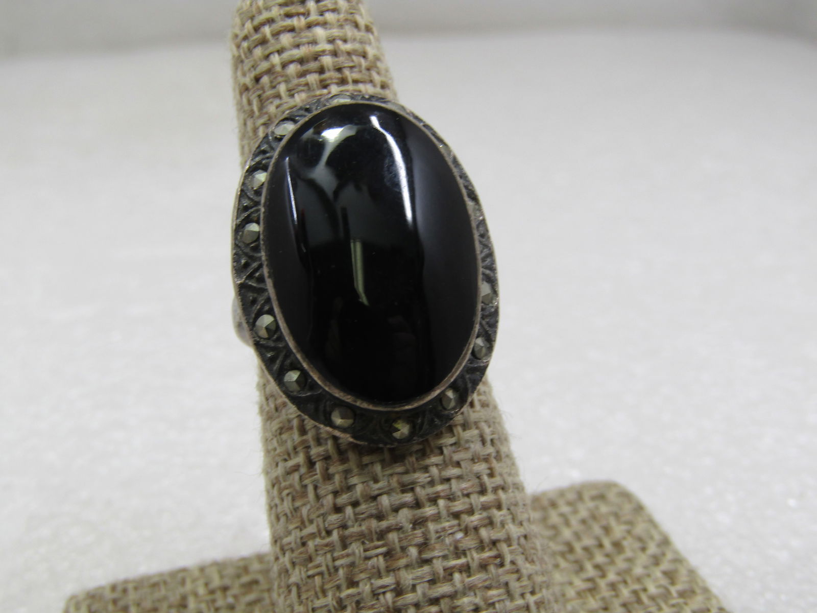 Vintage Sterling Oval Onyx Marcasite Ring, Sz. 7, 1970's-1980's: Vintage Sterling Oval Onyx Marcasite Ring, Sz. 7, 1970's-1980's. This has a black onyx oval that is appx. 23mm by 15mm with a bezel setting that sits higher than a marcasite frame around it. The top o