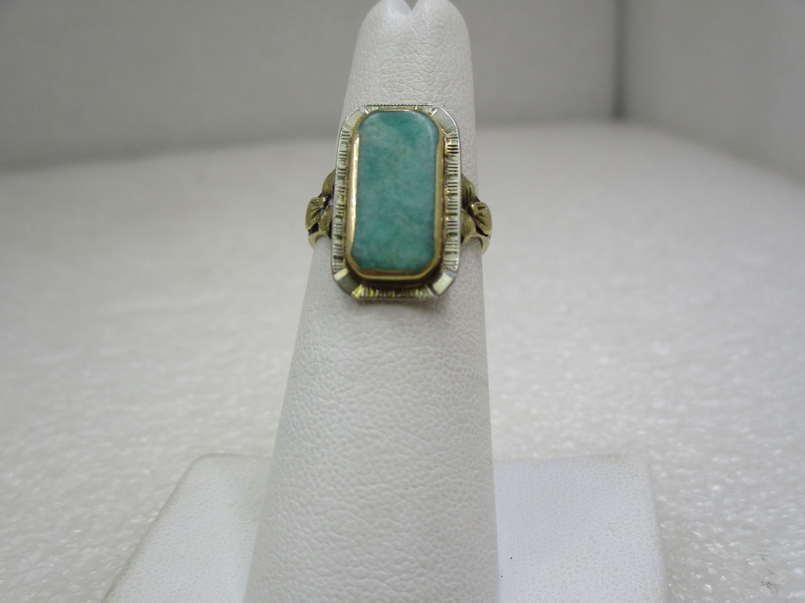 Vintage 1920's-1930's 10kt Green Stone Ring, sz. 5.5: Vintage 1920's-1930's 10kt Green Stone Ring, sz. 5.5. The stone is a long flat cabochon that is apx. 16mm by 8mm, bezel set in 10kt yellow gold on a 10kt white gold base and band. Their are bow accent
