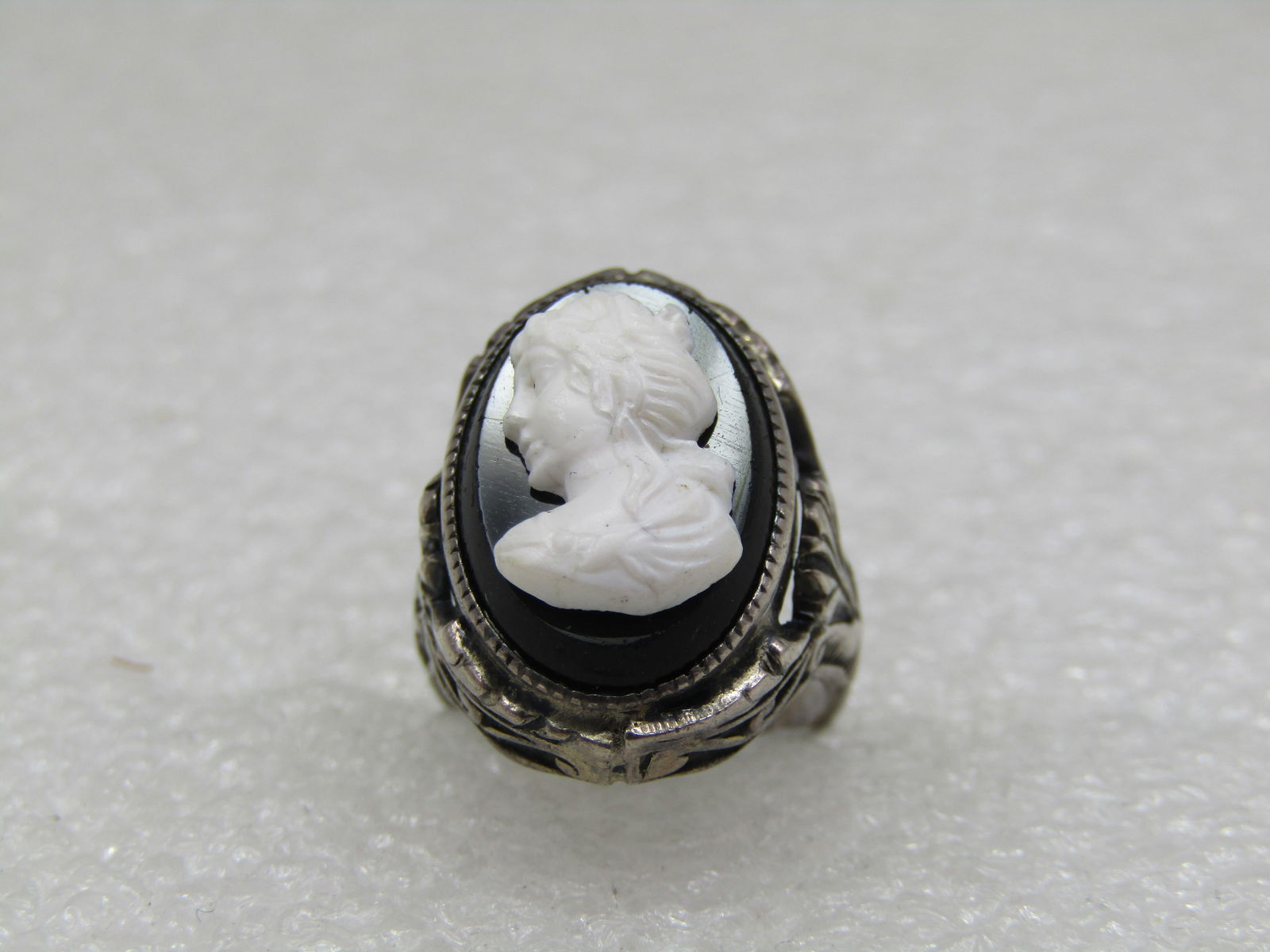 Vintage Sterling Cameo Ring, Sz. 3, Pre Mid Century: Vintage Sterling Cameo Ring, Sz. 3, Pre Mid Century. Black and white glass cameo with ornate setting and band, Victorian themed. Top of the ring is appx. 19mm by 14mm with a scrolled leaf design makin