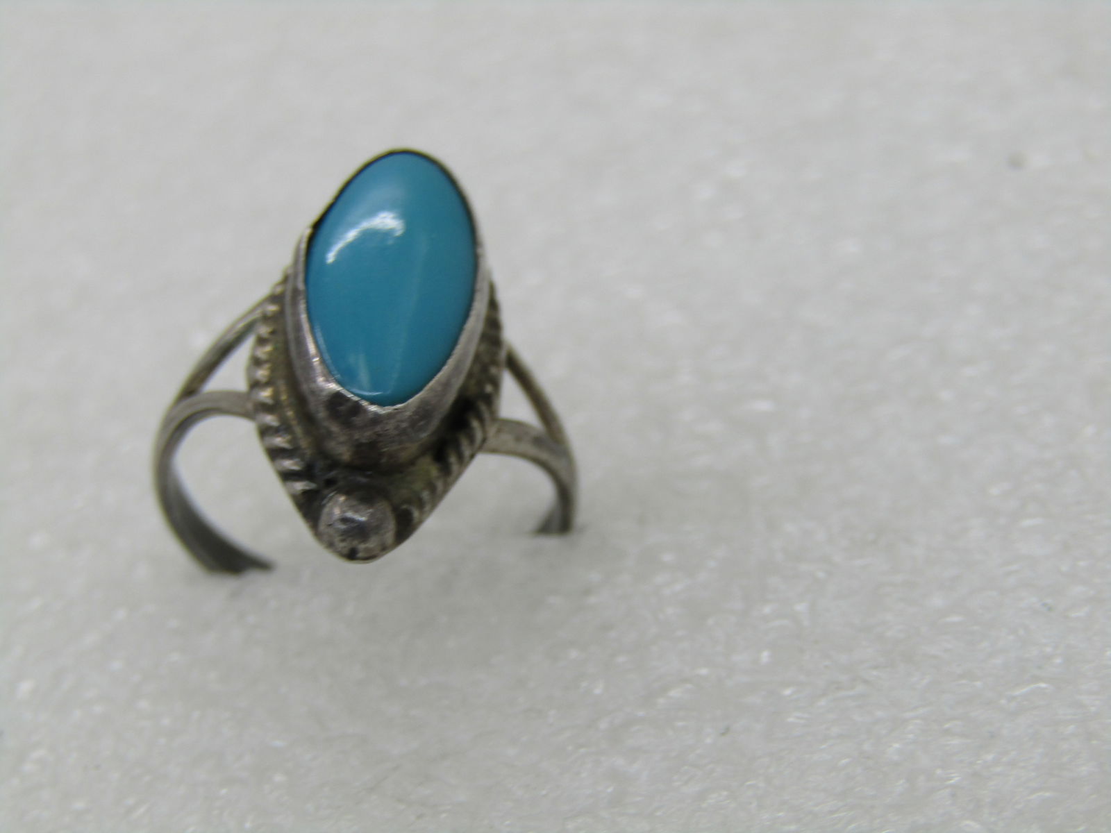 Vintage Sterling Southwestern Turquoise Ring, Sz. 5, Cateye Shaped: Vintage Sterling Southwestern Turquoise Ring, Sz. 5, Cateye Shaped. The stone is bezel-set and appx. 14.5mm long and 7mm wide. The top of the ring is appx. 21mm down the finger and 9.5mm across the fi