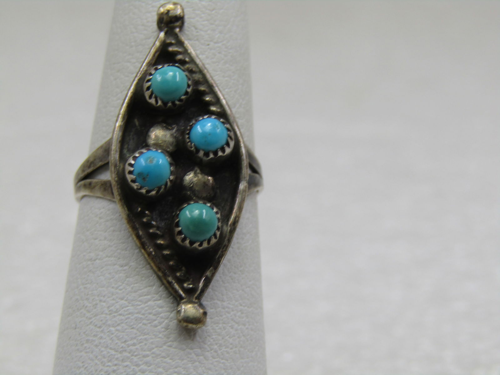 Vintage Sterling Southwestern Snake Eye Ring, Sz. 5.75, 1960's-1970's: Vintage Sterling Southwestern Turquoise Snake Eye Ring, Sz. 5.75, 1960's-1970's. The ring is cateye shaped with a bead on the tips going down the finger. The snake eye turquoise stones are 4mm