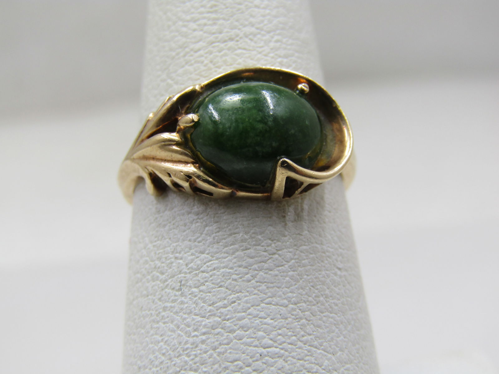 Vintage 10kt Jade Ring, Signed 6.5, Signed Kimberly. 1950's-1960's: Vintage 10kt Jade Ring, Signed 6.5, Signed Kimberly. 1950's-1960's. The jade is appx. 2 CTW set on it's long side across the top of the finer with prong and a swoop wrapping around one side of the sto