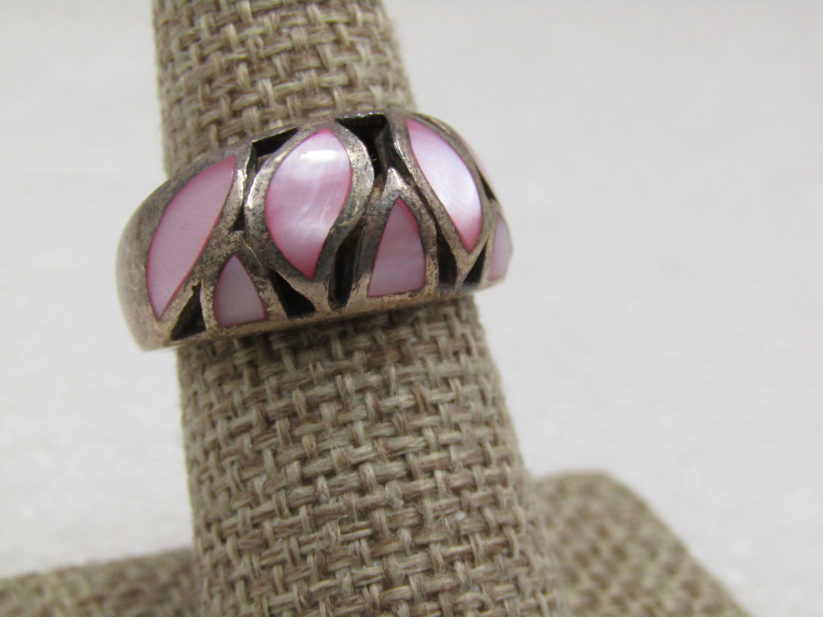 Vintage Sterling Pink Mother-of-Pearl Inlaid Band Ring, Sz. 8: Vintage Pink Mother-of-Pearl Sterling Inlaid Band Ring, Sz. 8. The ring is a domed pain with inlaid leaf-like shapes and marquise and other shapes with pink mother-of-pearl, lilkely dyed. The ring is
