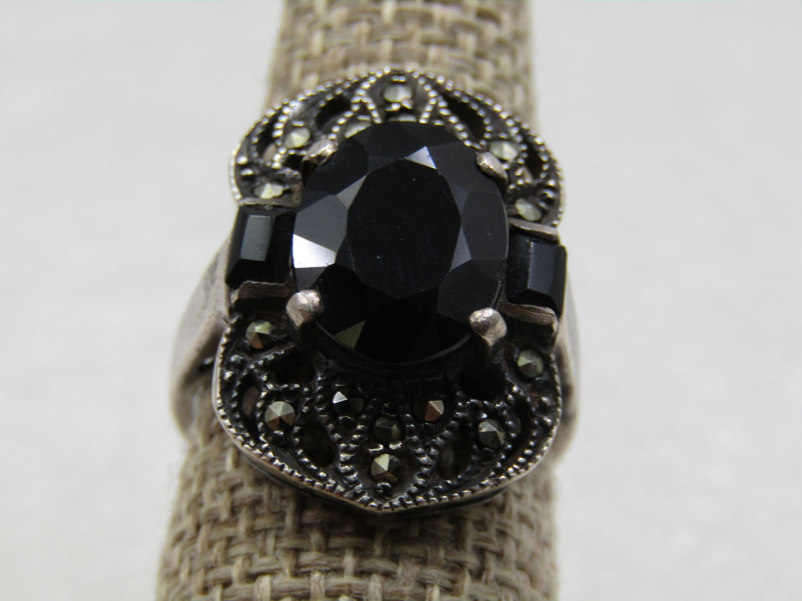 Vintage Sterling Marcasite & Onyx Ring. Sz. 8, Over 3 CTW: Vintage Sterling Marcasite & Onyx Ring. Sz. 8, Over 3 CTW. Chunky ring, marked .925, tested and signed TH. Weight of the ring is appx. 8.78 gr. It is appx. 24mm down the finger and 16mm across the fin
