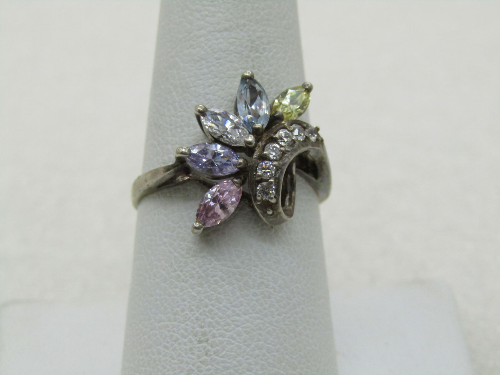Vintage Sterling CZ & Lab Created Ring, Art Deco Themed, Sz. 8.25: Vintage Sterling CZ & Lab Created Ring, Art Deco Themed, Sz. 8.25. Marquise stones that test as CZ and a few lab created in pale yellow, blue, lavender, pink, and clear. There is a curved band slightl