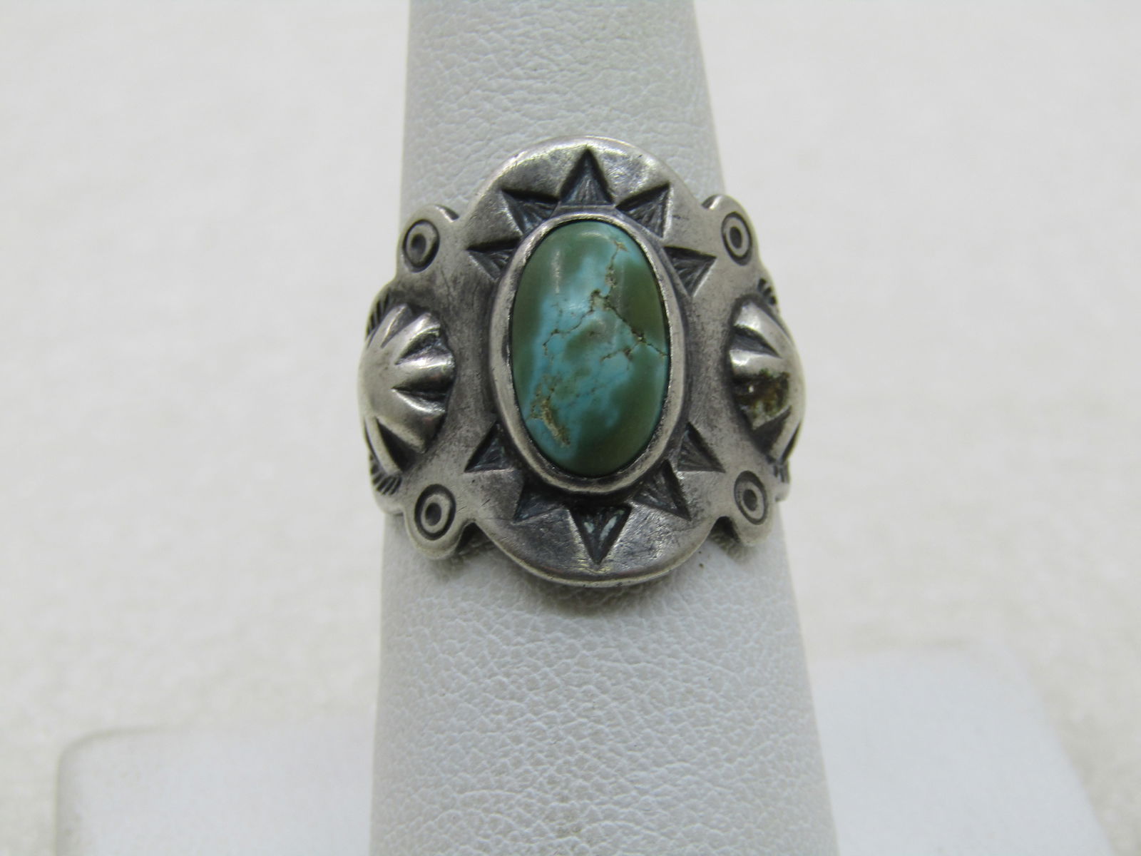 Vintage Sterling Southwestern Turquoise Ring, Open Back Adjustable, Unisex: Vintage Sterling Southwestern Turquoise Ring, Open Back Adjustable, Unisex. Age is post mid-century - 1960's-1980's. Stamped repousse ring with a center greenish oval turquoise that is bezel set and a