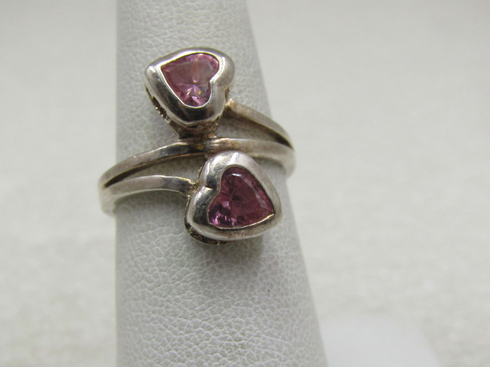 Silver Double Pink CZ Heart Bypass Ring, Sz. 6.75: Silver Double Pink CZ Heart Bypass Ring, Sz. 6.75. Signed CI and marked .925. It has am 8mm heart on each side of the bypass that has a bezel-set pink cz in each heart. There is a center band between