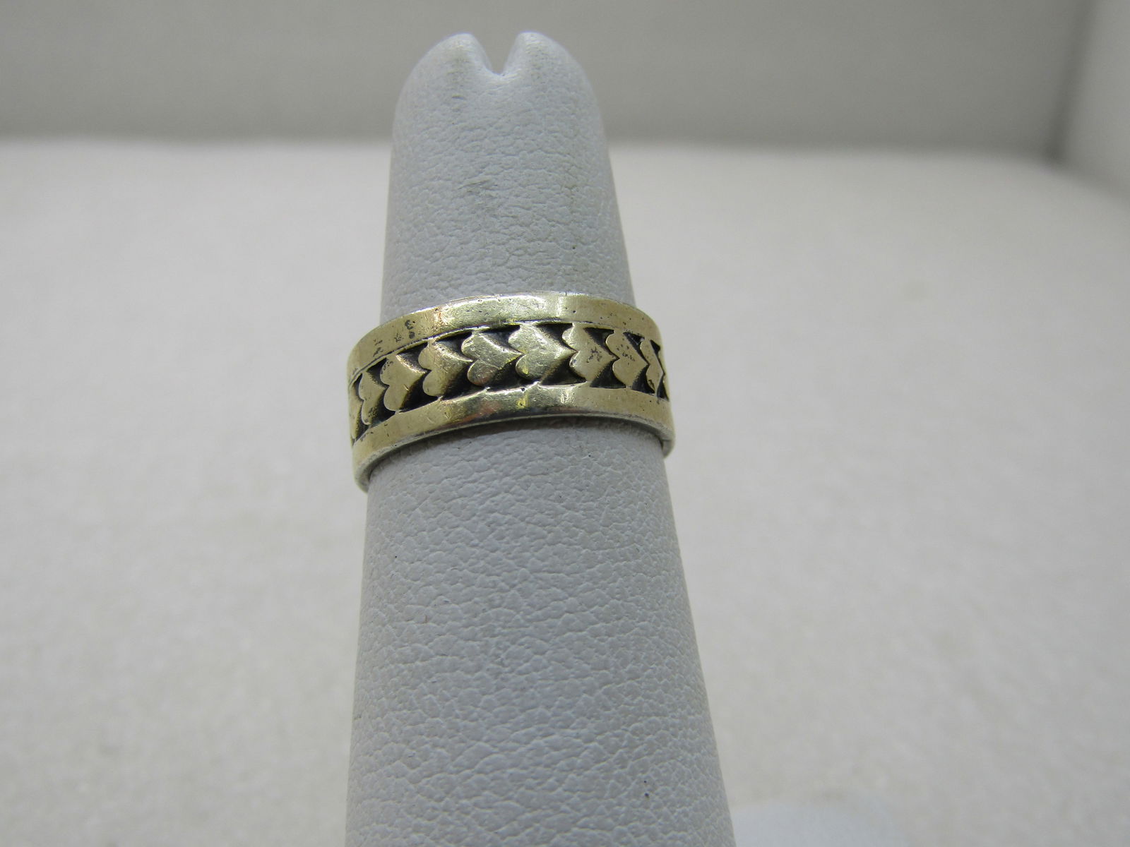 Vintage Sterling & 14kt Heart Wedding Band, Sz. 5, 6.5mm: Vintage Sterling & 14kt Heart Wedding Band, Sz. 5, 6.5mm. The center of the ring has hearts which are 14kt. The balance of the ring is sterling silver. The hearts are a gold tone but in certain lights