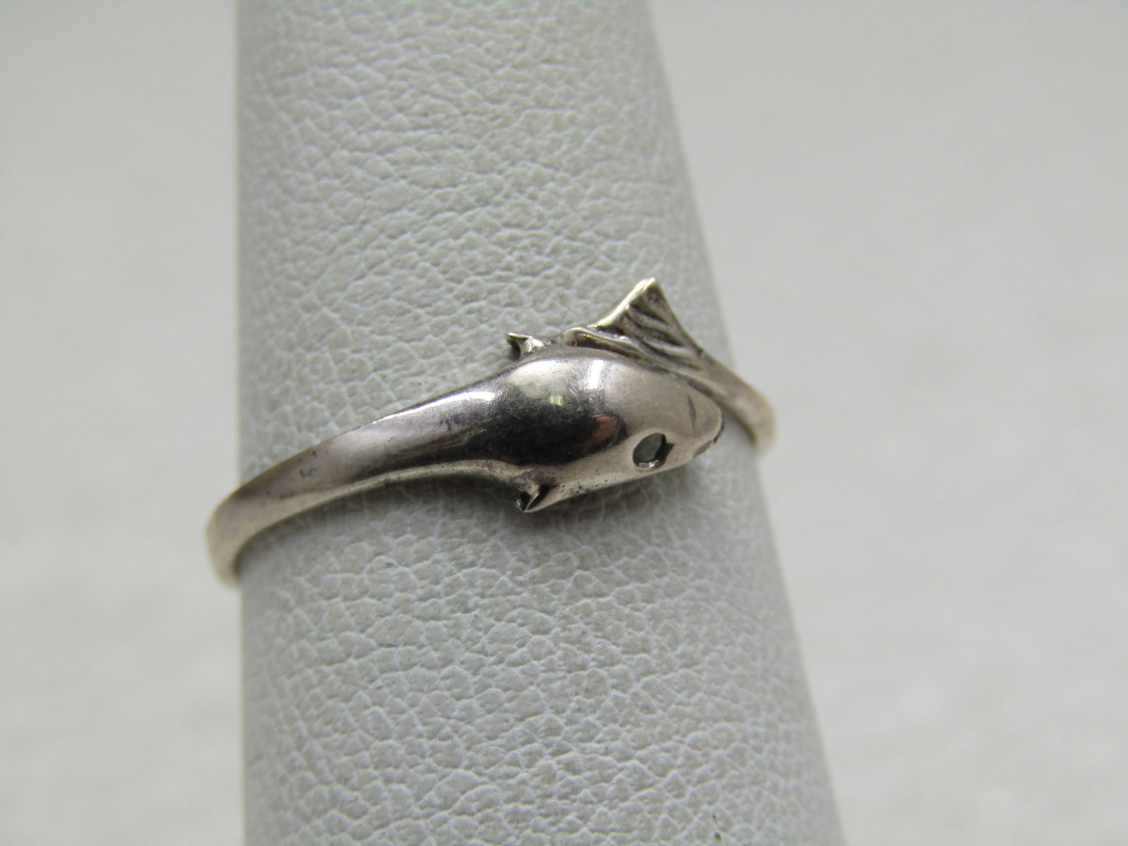 Sterling Silver Dolphin Bypass Ring, Sz. 6.5: Sterling Silver Dolphin Bypass Ring, Sz. 6.5 and appx. .90 grams. Marked sterling and tested. The ring is appx. 6.5mm at top where the tail and the head meet. The ring tapers to appx. 1.8mm at the