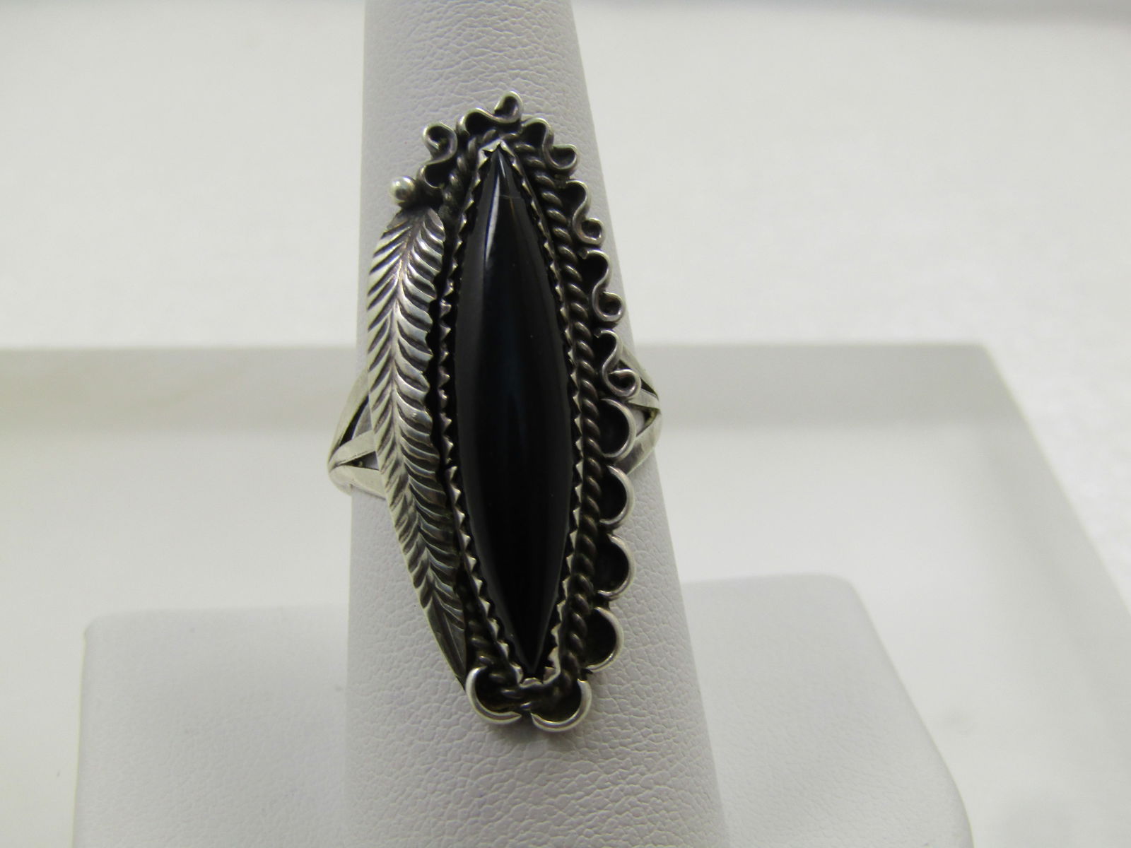 Vintage Sterling Southwestern Onyx Rng, Sz. 8.5, 1970's: Vintage Sterling Southwestern Onyx Rng, Sz. 8.5, 1970's estimated era. This has a long pointed black onyx stone that is appx. 29mm long and 7mm wide set in a sawtooth bezel-setting with a rope acdcent