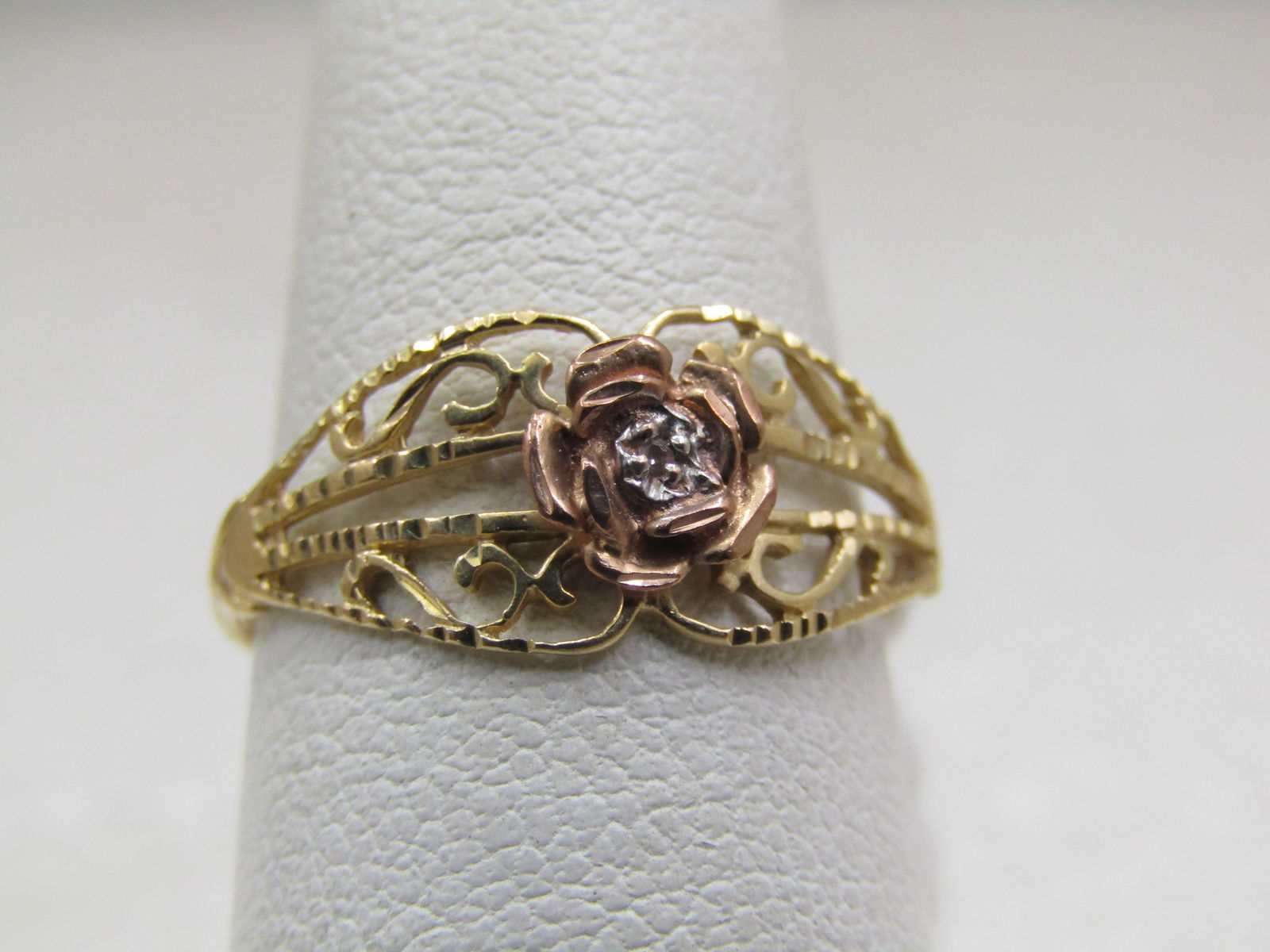 Vintage 10kt Filigree Rose Ring with Diamond, Sz. 6.5, Signed JCM, Two-Tone.: Vintage 10kt Filigree Rose Ring with Diamond, Sz. 6.5, Signed JCM. It is appx. 8.5mm down the finger and appx. 1.3mm wide at the back of the finger. It is yellow gold filigree wide band ring on top of