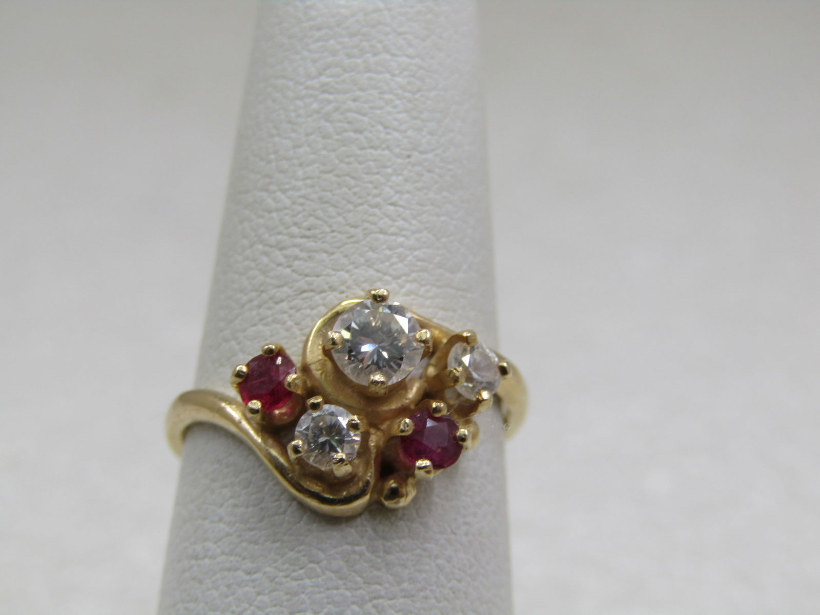 Vintage 14kt Moissanite Ruby Cluster Ring, Sz. 6: Vintage 14kt Moissanite Ruby Cluster Ring, Sz. 6. Two round cut rubies appx. 2.5mm and 2.7mm. There is a large clear stone that looks like a diamond and tests as a diamond but also moissanite and I