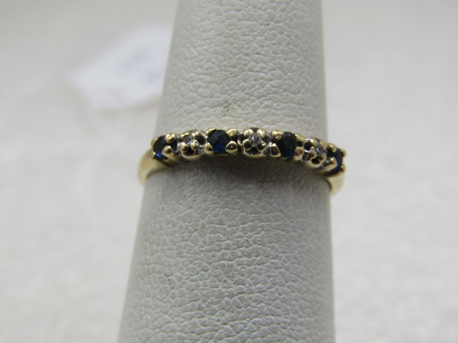 Vintage 14kt Sapphire Diamond Band Ring, Sz. 5.5. 2.5mm: Vintage 14kt Sapphire Diamond Band Ring, Sz. 5.5. 2.5mm wide with four 1.5mm blue sapphires and three diamond chips, all prong set. Signed with what looks like FM and also marked 14kt and tested.