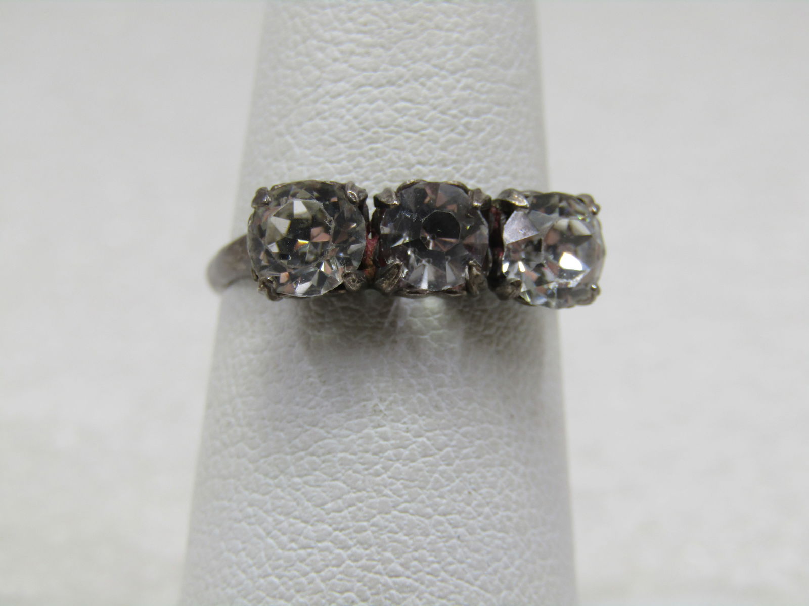 Vintage Sterling Triple Clear Glass Ring , Uncas, Sz. 6.5: Vintage Sterling Triple Clear Glass Ring , Uncas, Sz. 6.5. Three stones that are appx. 5.3mm to 5.5mm, prong-set and are almost flat across the top of the finger. The band is 1.9mm wide. Marked sterli