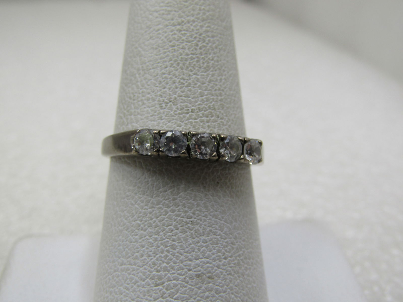 Vintage Sterling Multi-CZ Ring, Sz. 8.25, 3mm , Signed JC: Vintage Sterling Multi-CZ Ring, Sz. 8.25, 3mm. Five appx. 3mm round czs on top of the ring - like an anniversary ring. The czs cross the top of the finger. The ring is marked .925 and tested. Weight