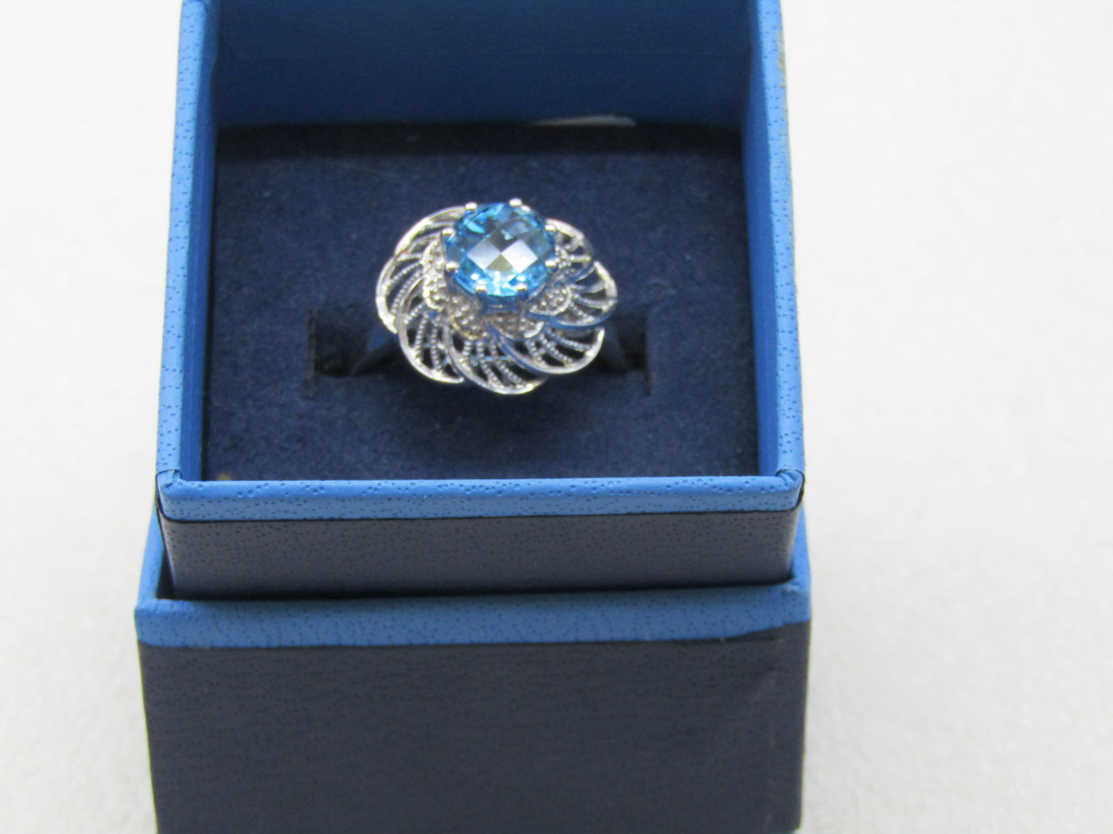 Sterling Silver Lab Topaz Ring, Sz. 10.5, Filigree Spiral: Sterling Silver Lab Topaz Ring, Sz. 10.5, Filigree Spiral Top that is appx. 16mm across. Weight is appx. 4.25 gr. The stone is appx. 8mm round 8 prongs holding it above the filigree setting. The band