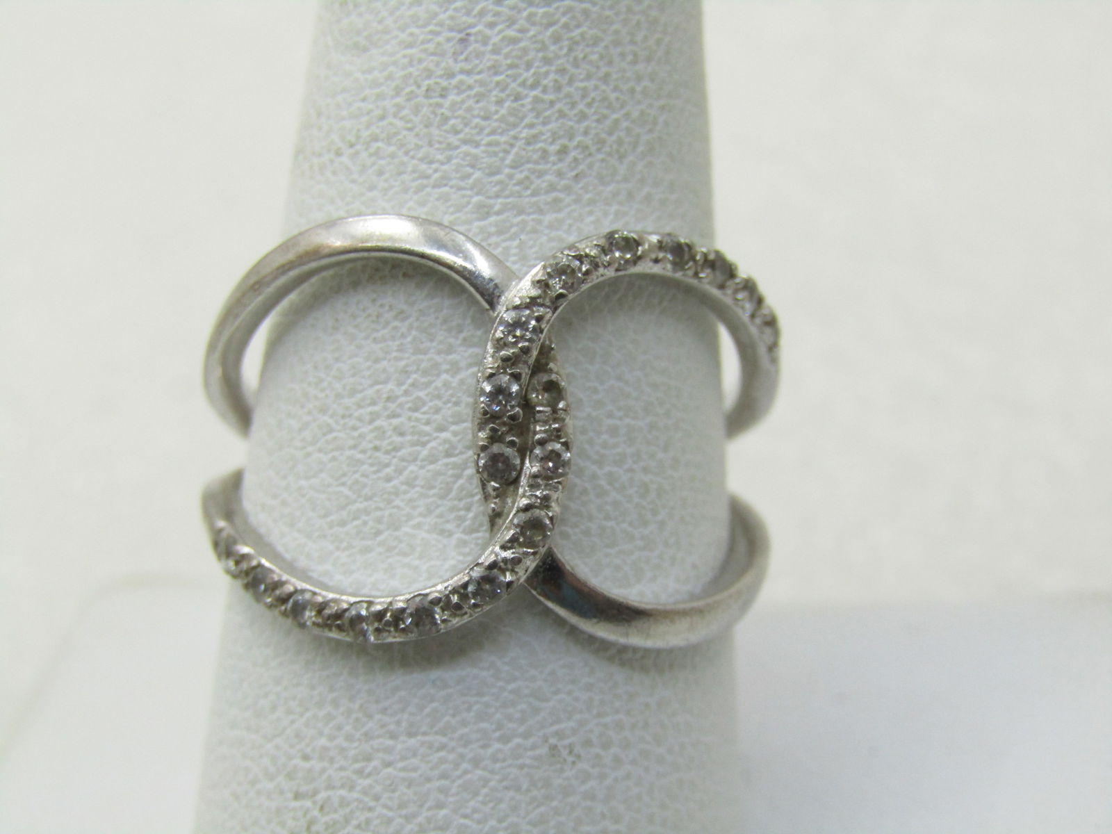 Sterling Silver CZ Wided Looped Ring, Sz. 9, 20 CZ, Signed NVC (Nataliya Collister): Sterling Silver CZ Wided Looped Ring, Sz. 9, 20 CZ, Signed NVC. Tested too. 3.36 grams. 20 CZs' wo in ech loop, one loop is a smooth and shiny finish and the other a textured - each loop as 10 clear c