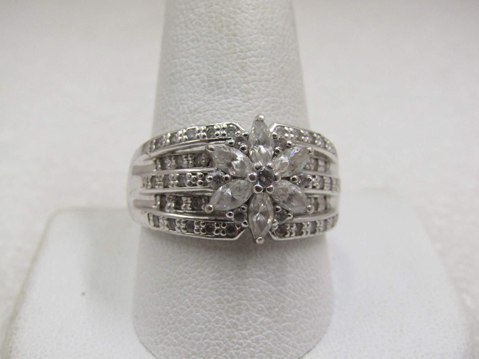 Vintage Sterling Wide Blossom CZ Ring, Sz. 11.5, Signed: Vintage Sterling Wide Blossom CZ Ring, Sz. 11.5, Signed SU .925 and CZ. There are five tiered bands over the top of the finger that are appx. 11.5mm down the finger at center and taper to 9mm where it